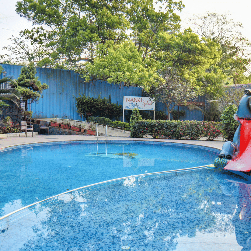 An outdoor swimming pool with a water slide feature at VITS Lonavala.