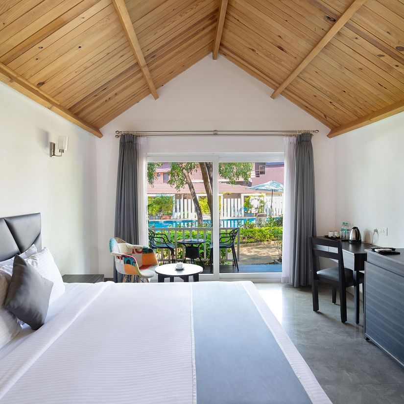 A side view of the bedroom shows an entrance to the patio - White Wood Resort, Morjim