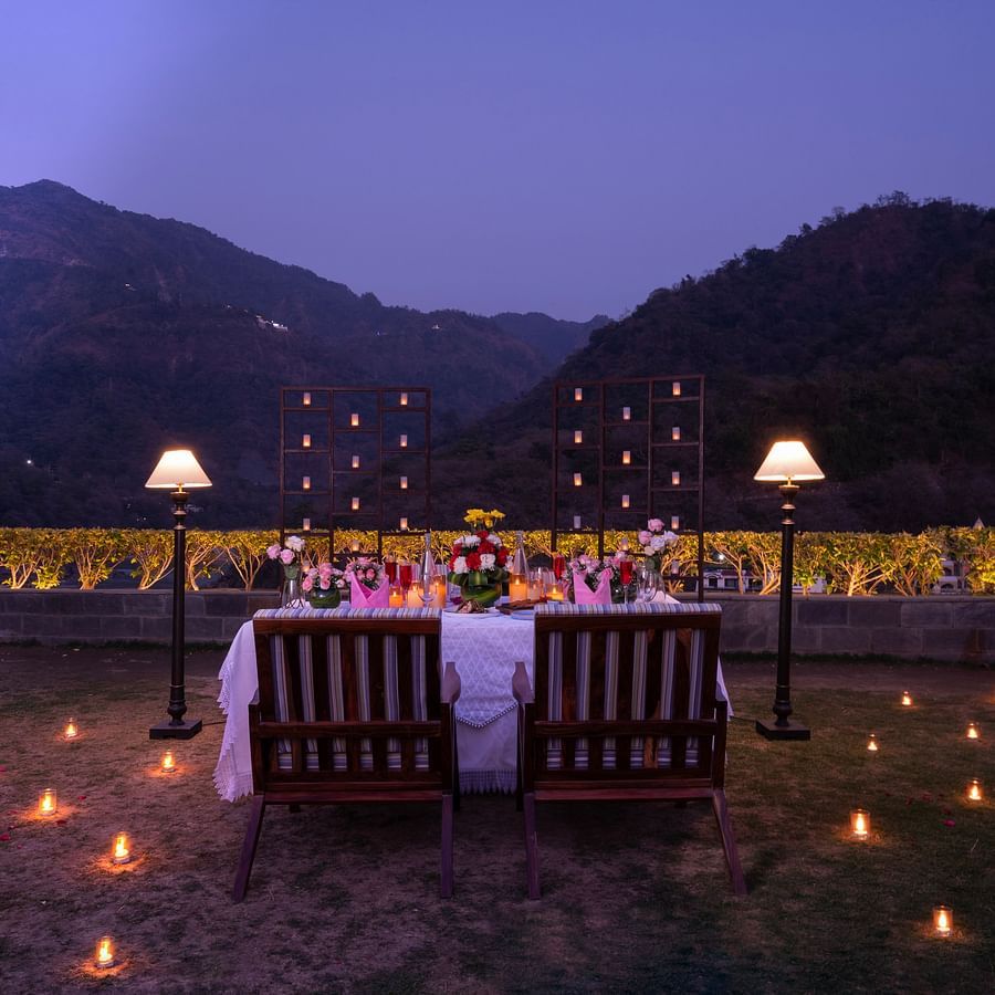 A wide angle view of the dining decorated well with lights during evenings with beautiful backdrop of mountain