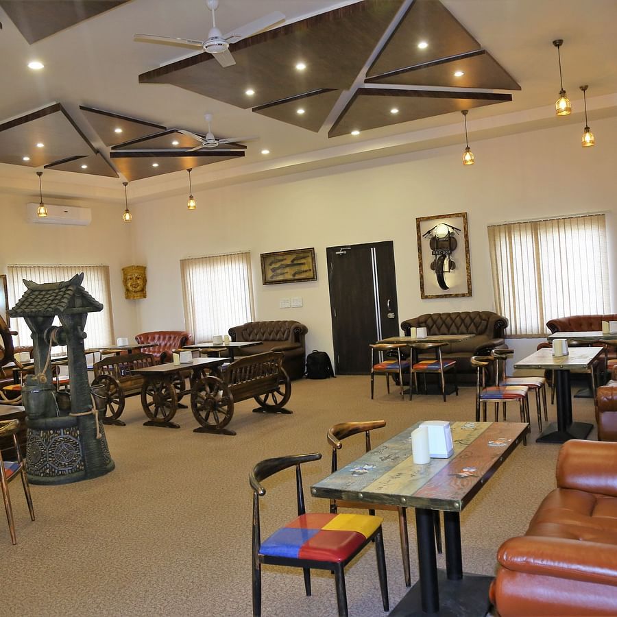 The spacious bar furnished with cart-shaped interiors and curated touches at GK Hill View Resort.