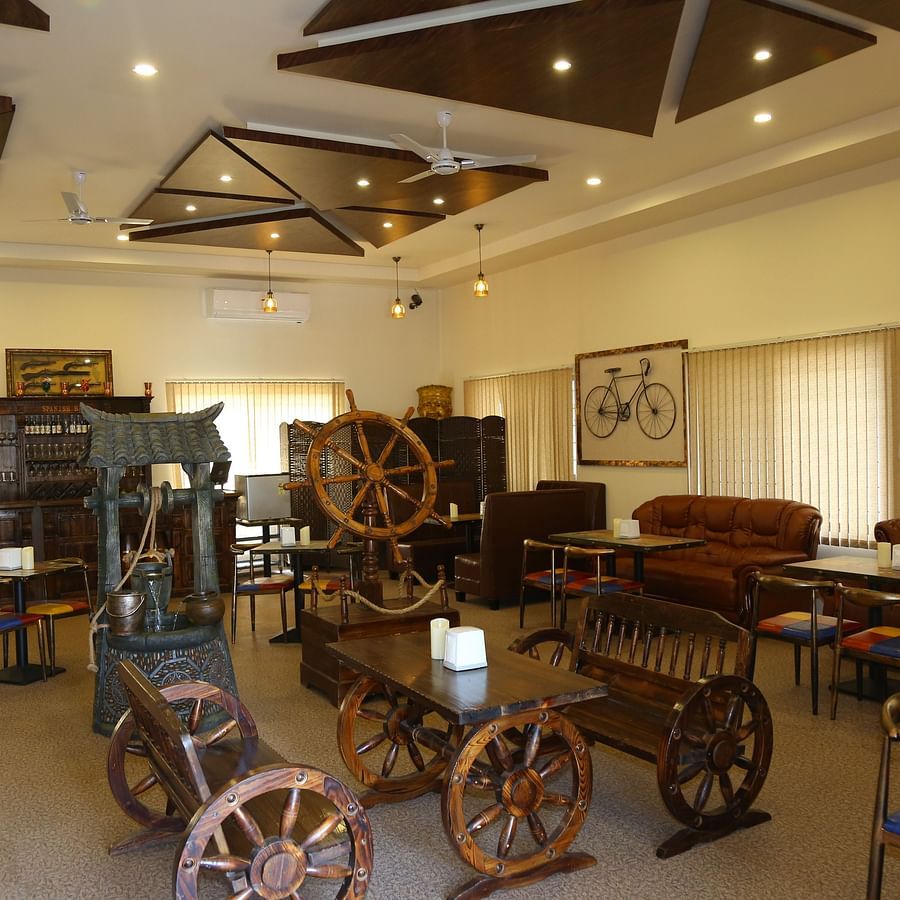 Bar of GK Hill View Resort furnished with cart-shaped furniture, ample lighting and intimate interior touches.