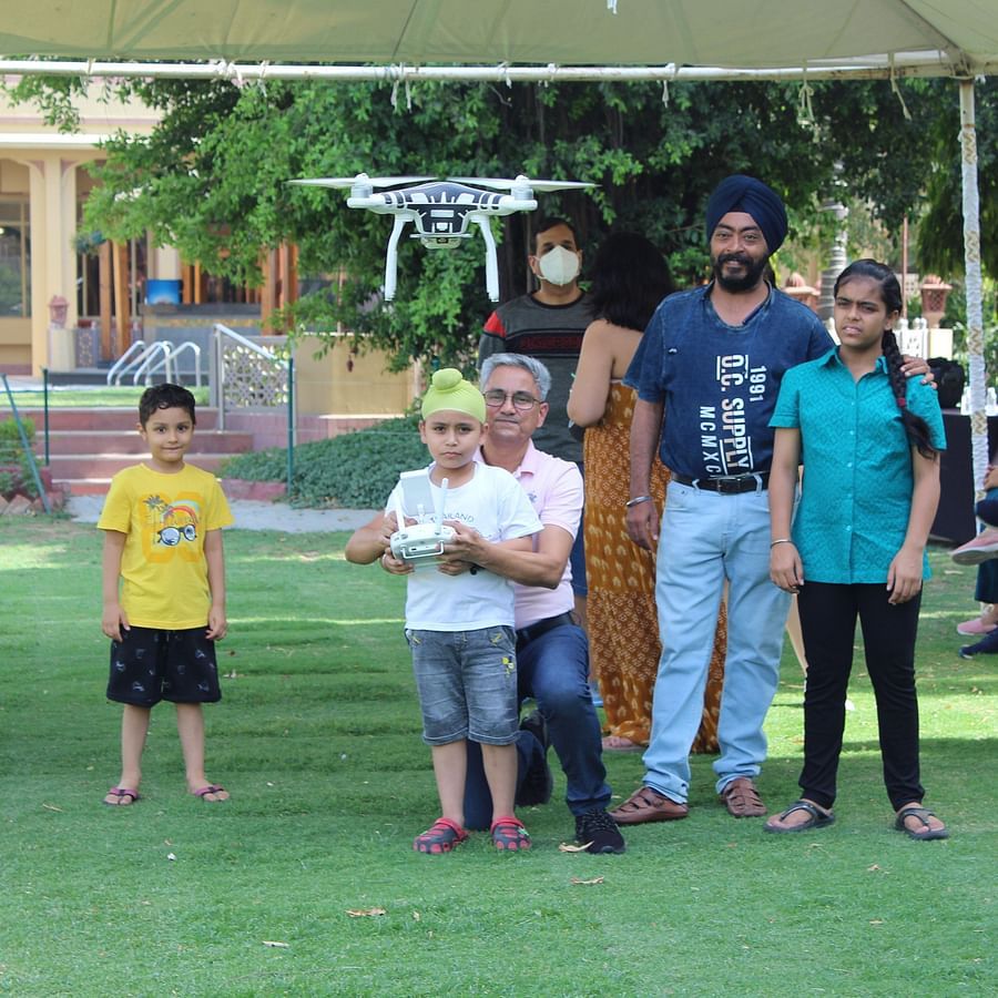 Heritage Village Resorts Manesar - image of an instructor helping a child fly a drone