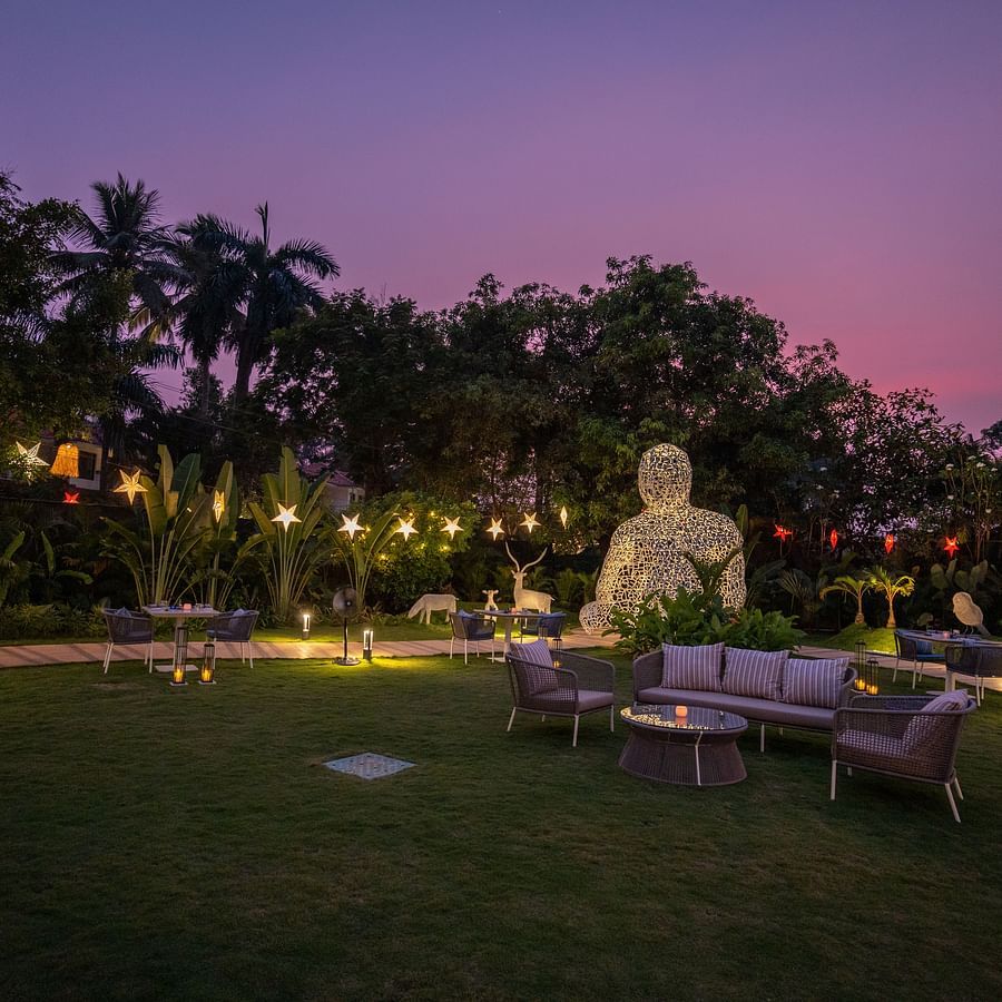 A lush garden with seating arrangements at Heritage Village Resorts & Spa.