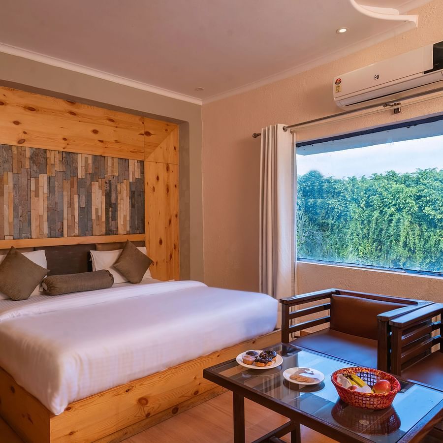 Room with sofa seating and scenic view at The Tattwaa Corbett Spa & Resort.