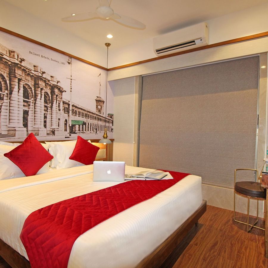 room with a king size bed and television in khar at theory9