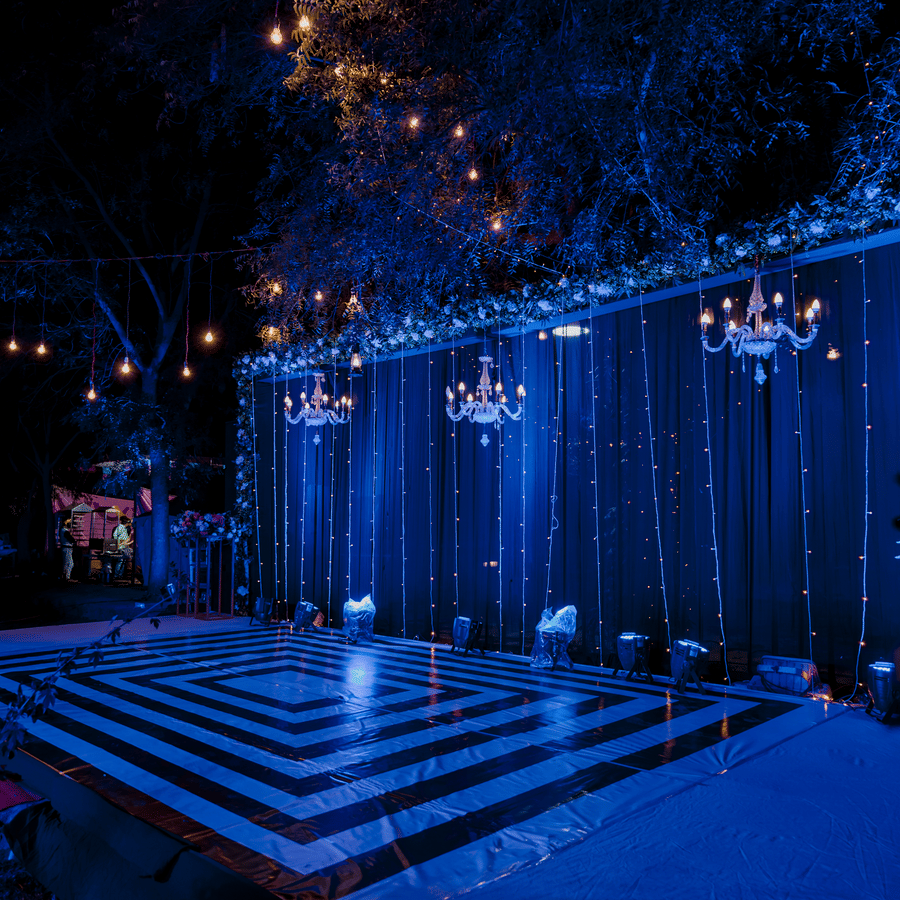 Elegant wedding stage setup with ambient lighting for evening celebrations.