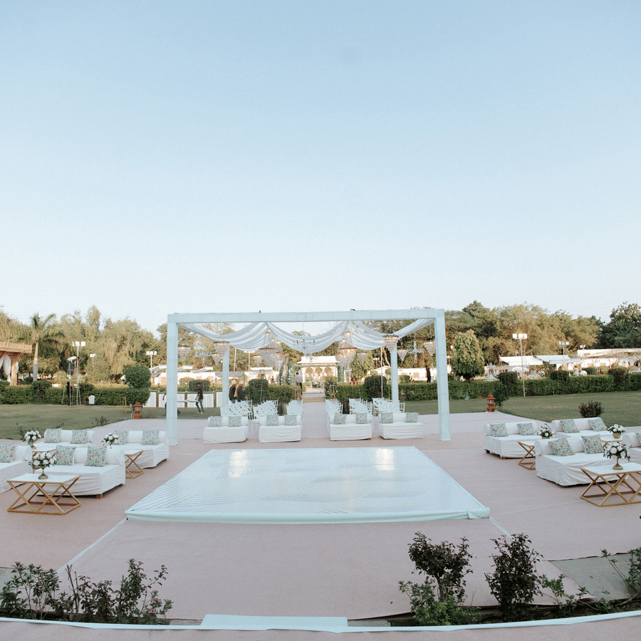 Outdoor lawn wedding setup with mandap and seating arrangement at Umaid Palace.