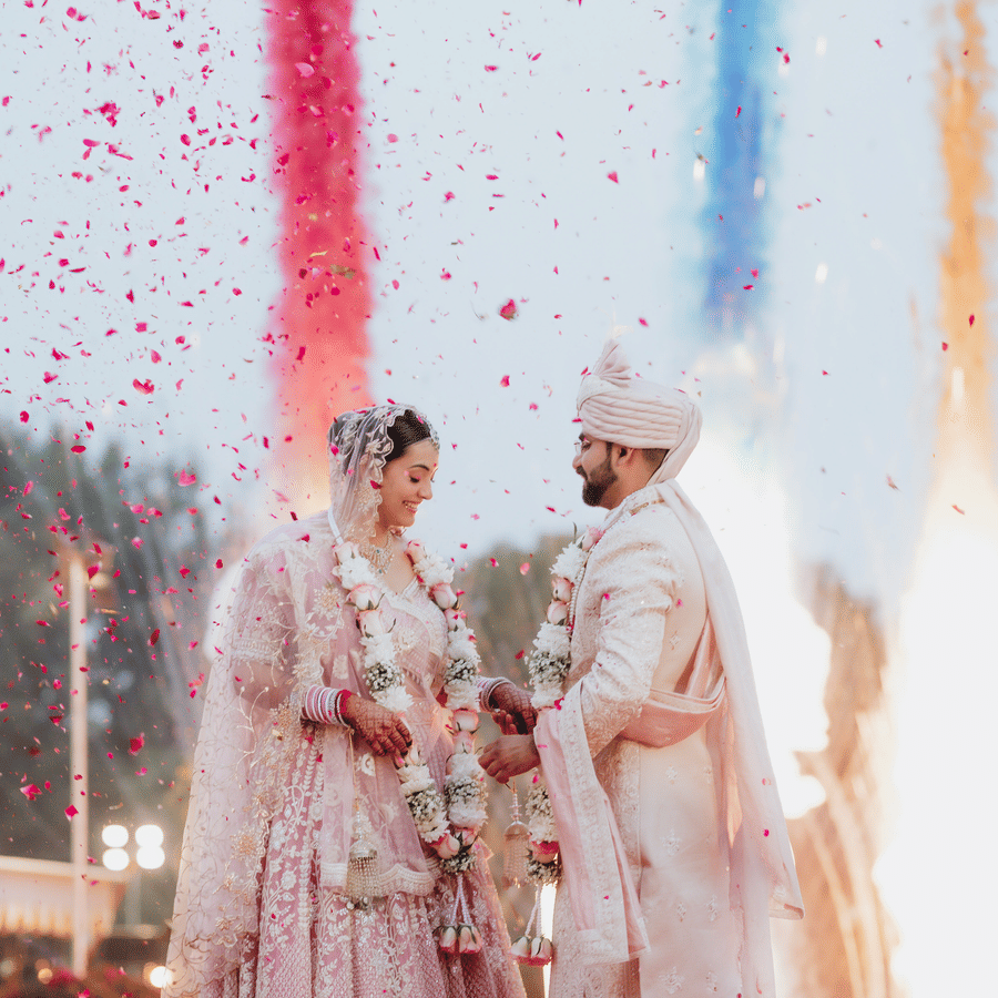 Couple performing wedding rituals with fireworks and vibrant colours at Umaid Palace