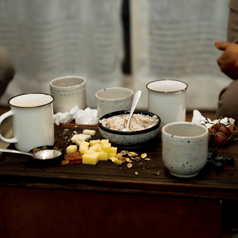 Traditional Ethiopian coffee ceremony with small cups served on a low wooden table.