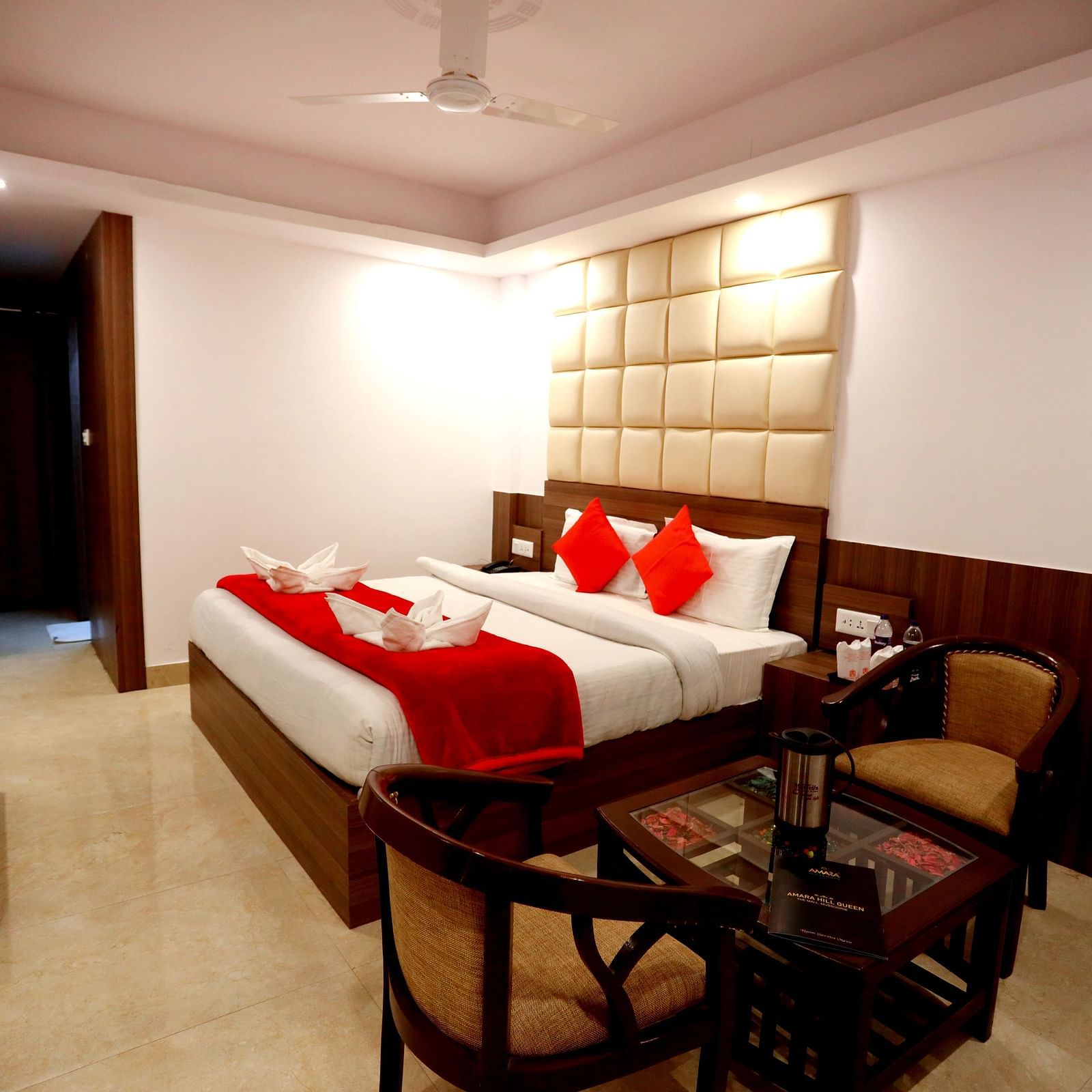 Side view of a room with a bed and a seating area on the side Amara Hill Queen, Mussoorie.