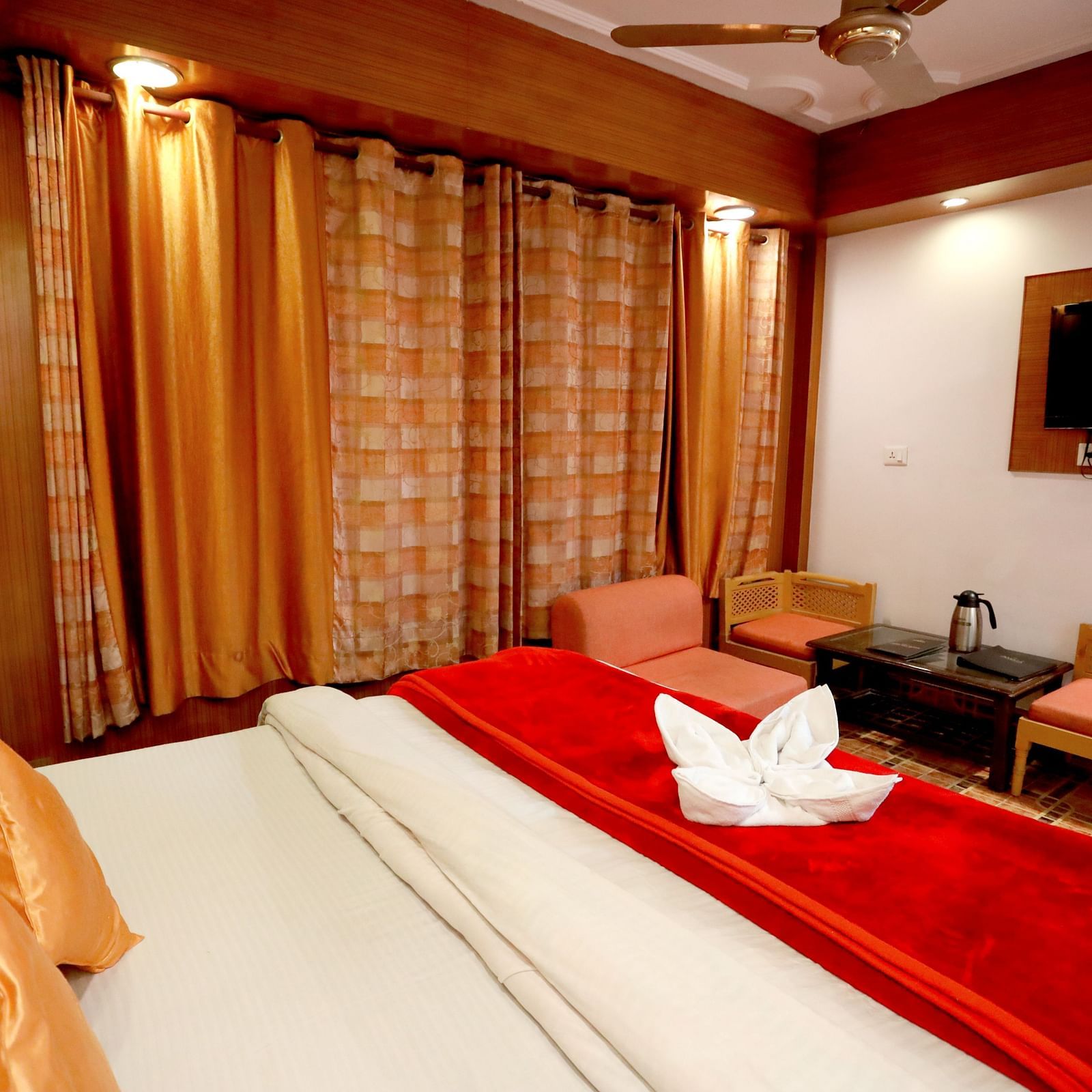 Image of a room with a bed and a television in front at Amara Hill Queen, Mussoorie.