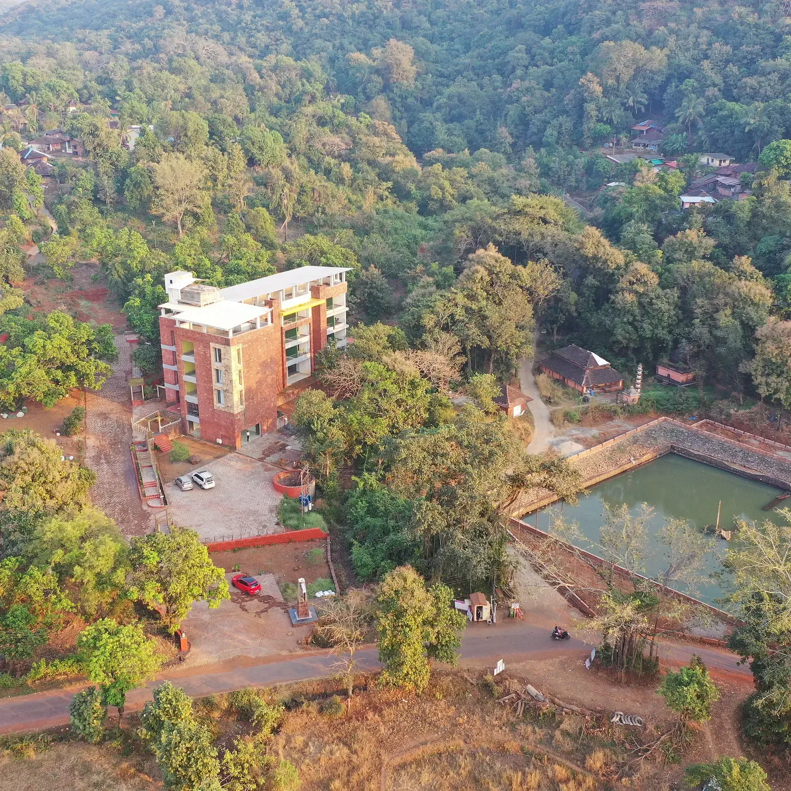 An overview of SeaFort Beach Resort surrounded by lush greenery and a water body nearby.