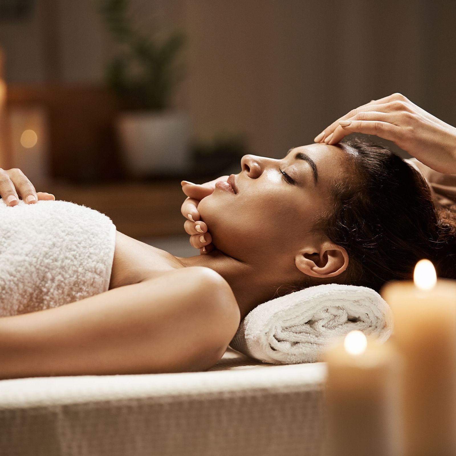 image of a woman recieving a relaxing and rejuvenating spa from a  masseuse 