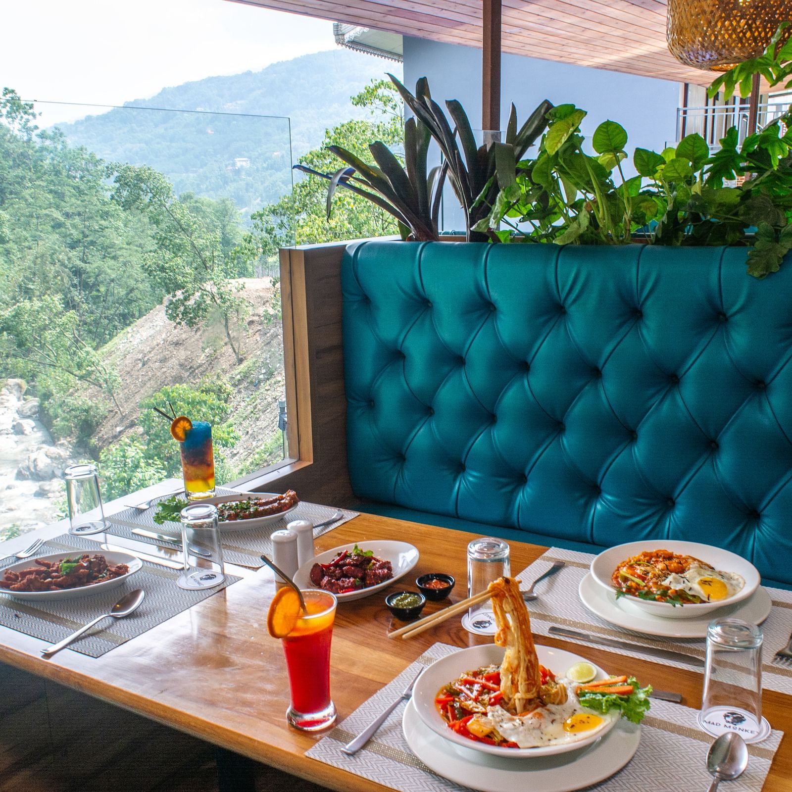 Image of a dining sapce with view of the river and nature surrounding it at Avianna Ganagtok Resort and Spa