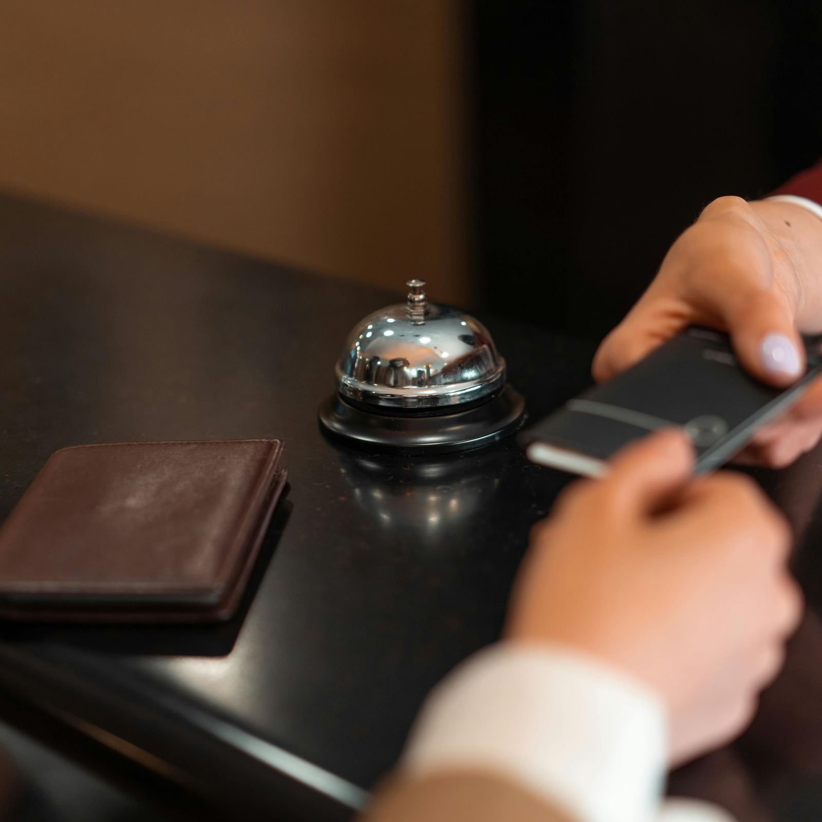 Hotel staff member handing over a key card at the reception desk