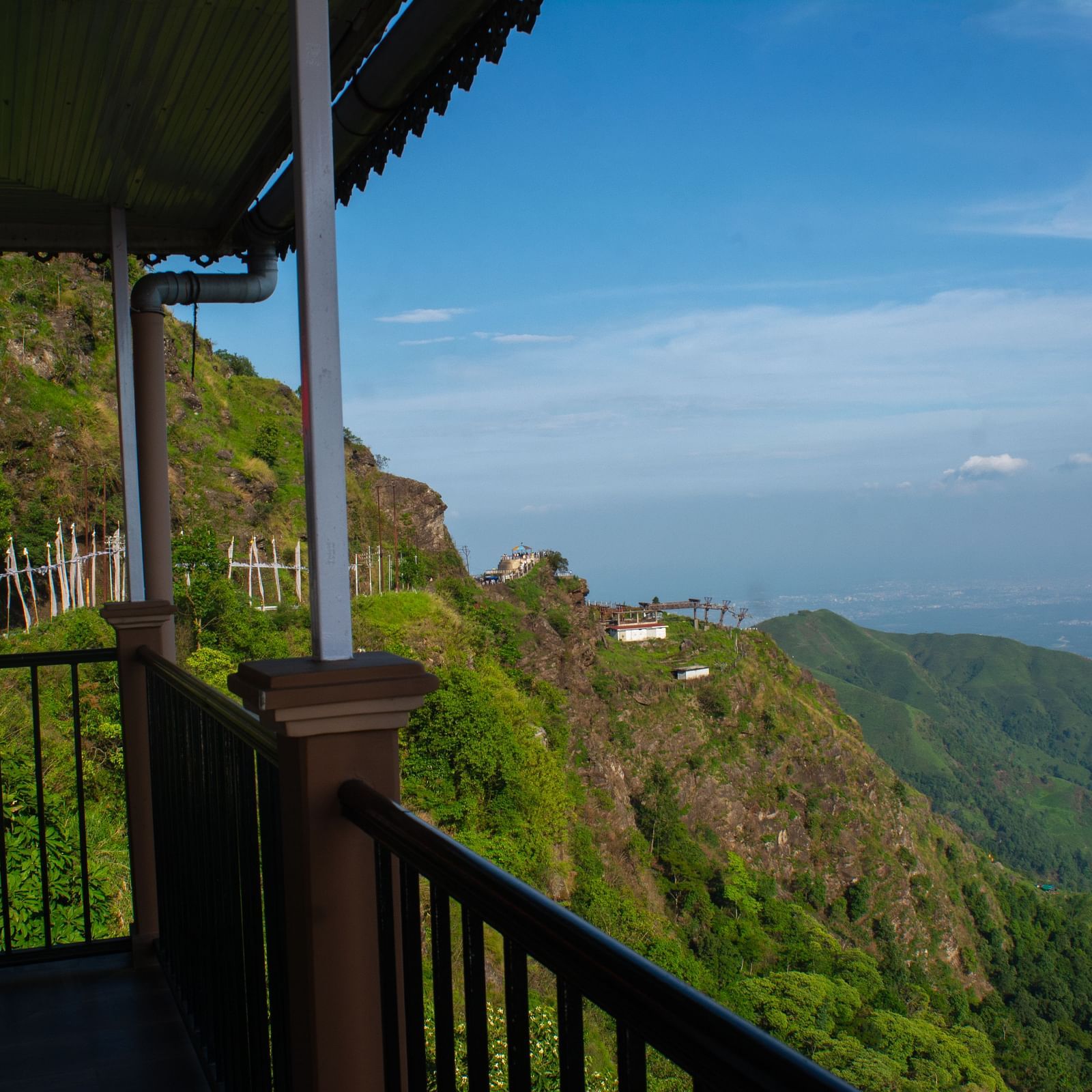 Valley view from a balcony showcasing mountains and clear sky