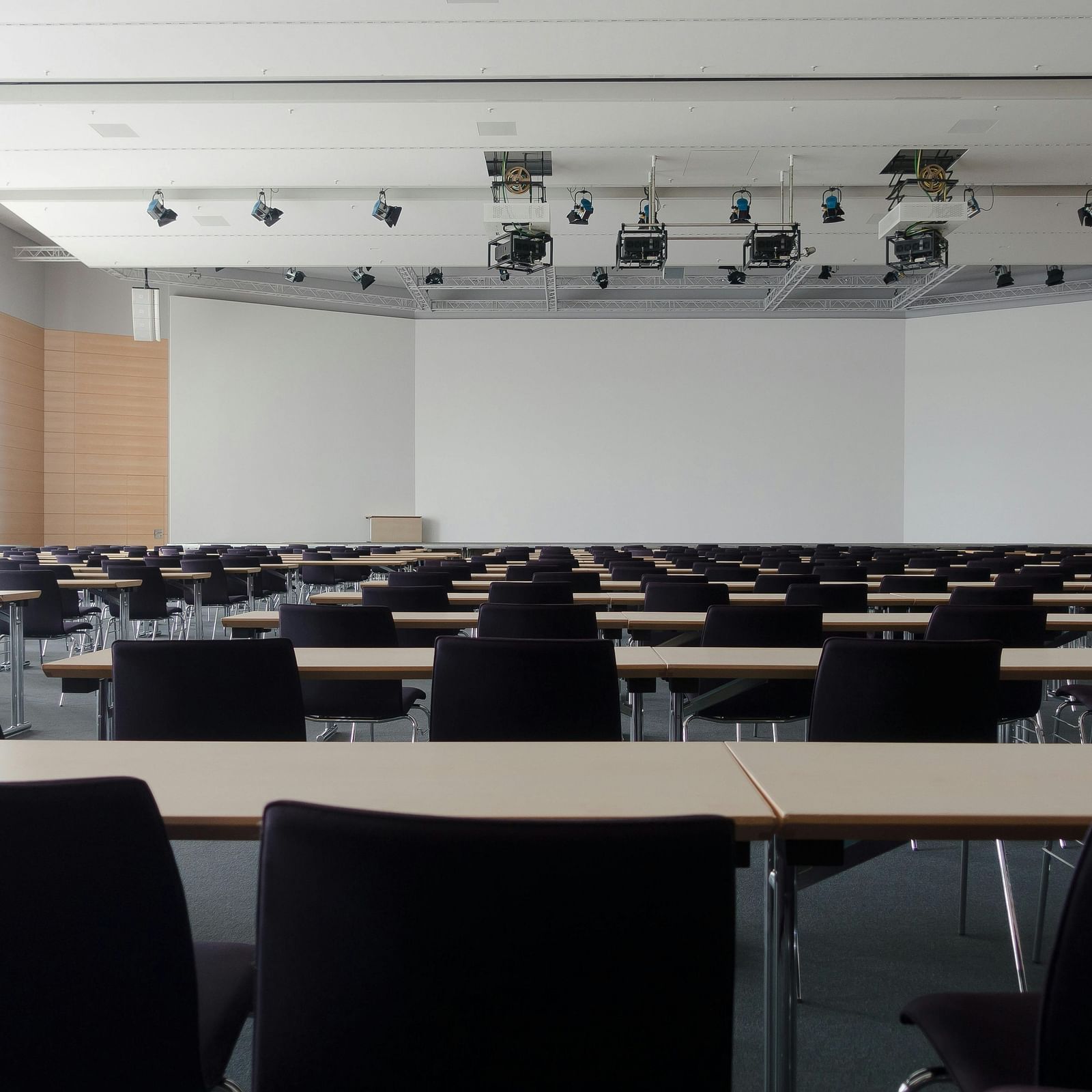 an image of conference hall with chairs and tables 