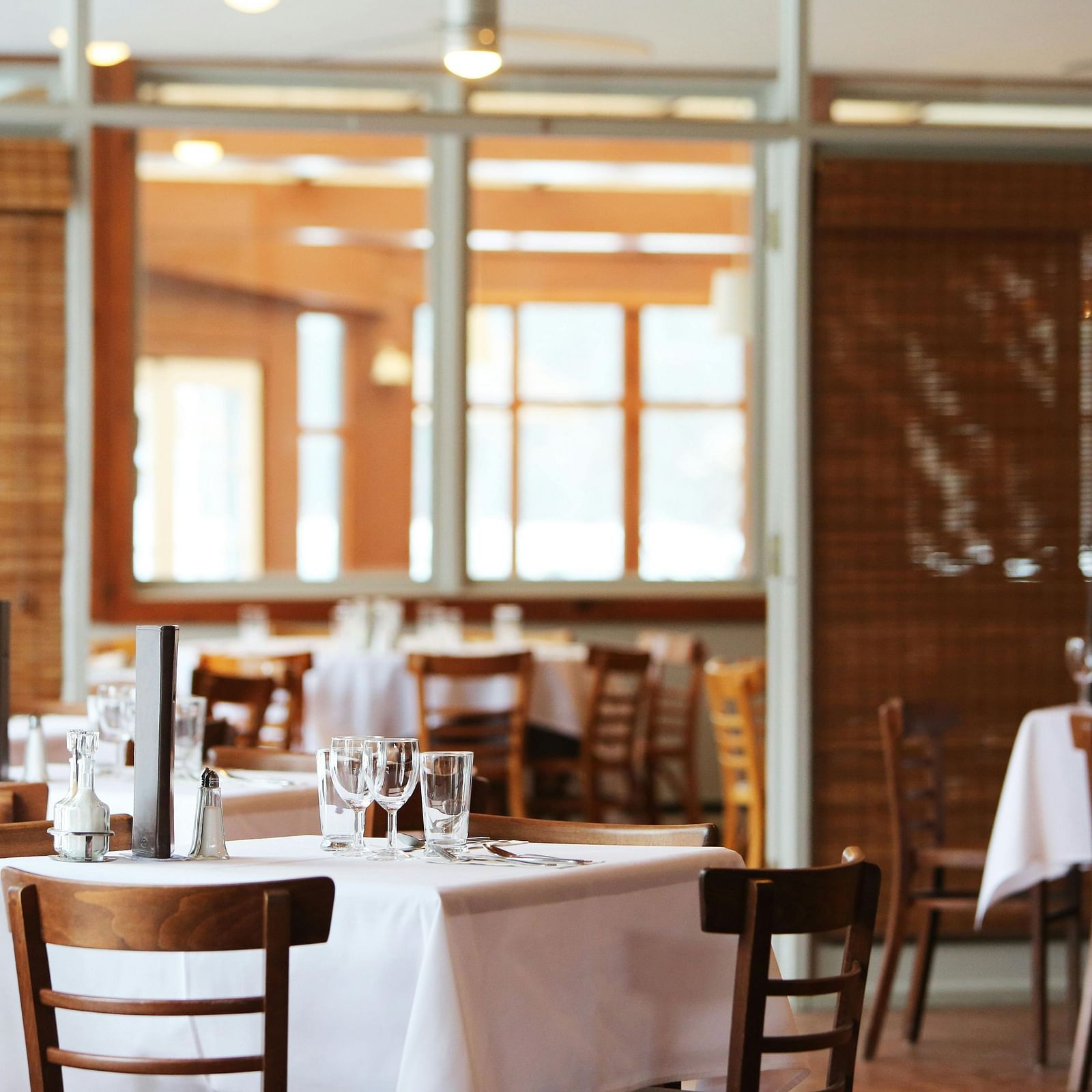 A dining area with comfortable seating, culinary delights neatly arranged on the table, and a warm, inviting ambiance