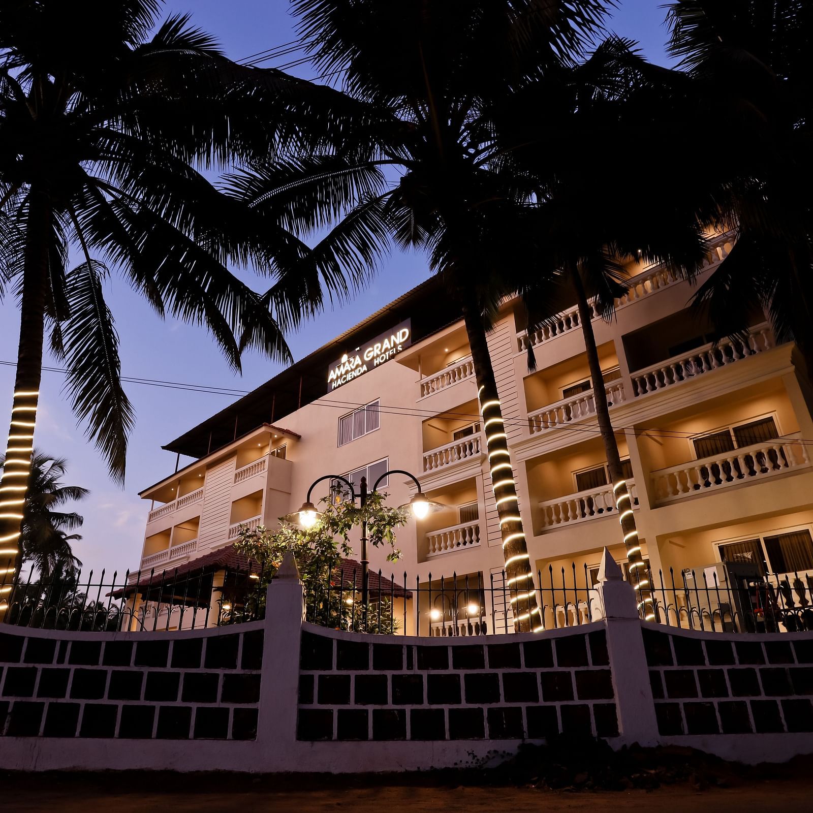 Facade of Calux Grand Baga with trees on the side.