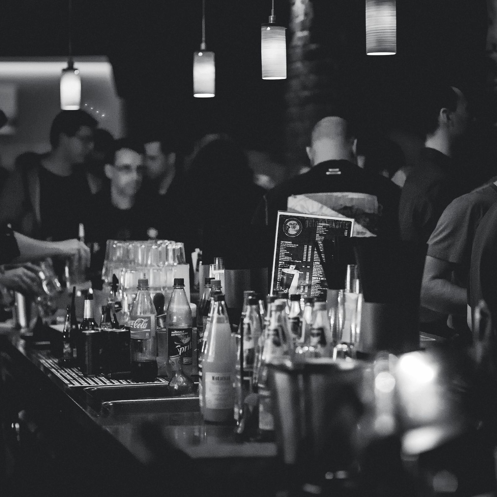 a bar counter with alcohol in bottles