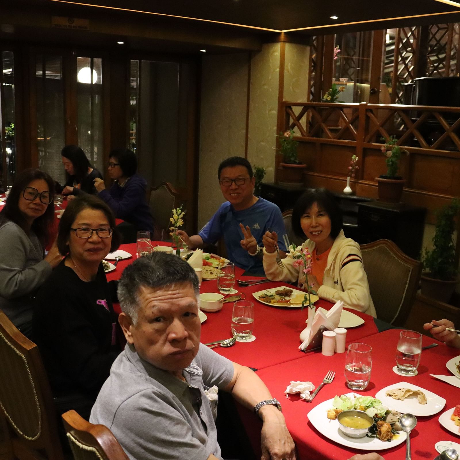 People dining in Cedar Inn in Darjeeling with warm overhead lighting.