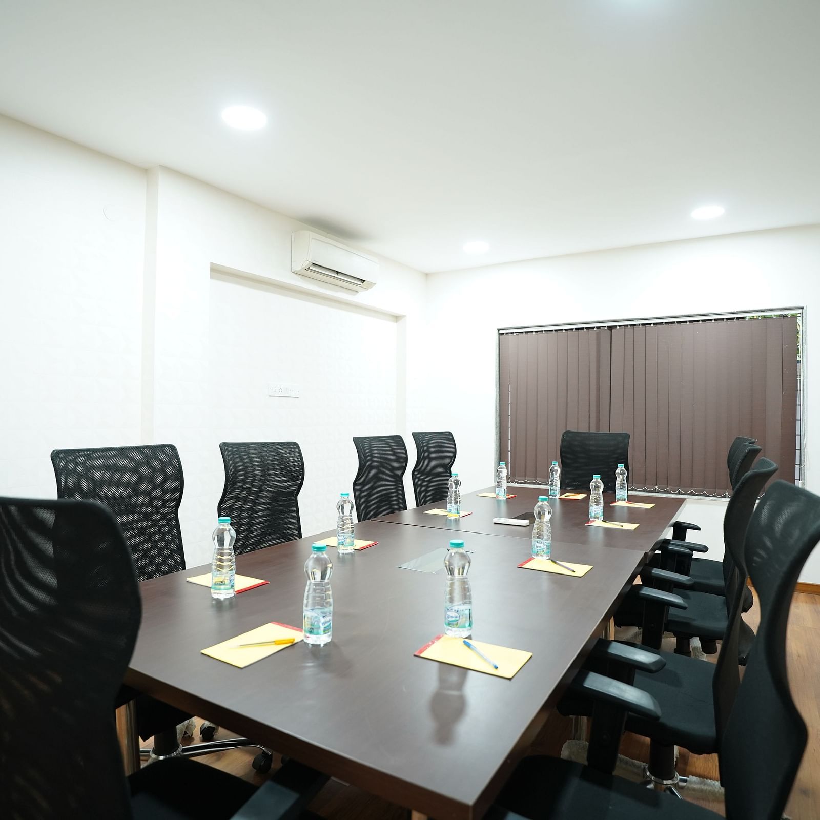 an image of a boardroom with a long wooden table and chairs at  City Centre Residency, Bangalore