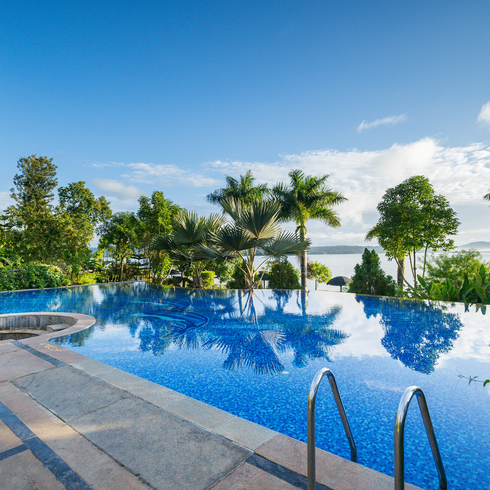 Image of a swimming pool with trees surrounding it at Coorg Jungle Camp Backwater Resort, Kushalnagar.