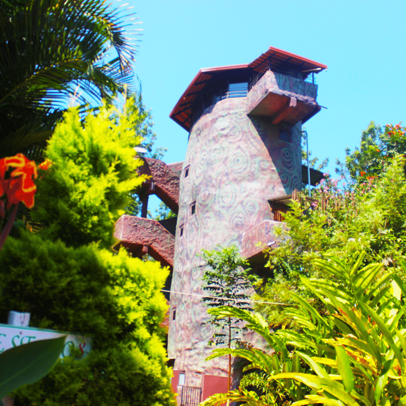 Image of the facade of an accommodation surrounded by trees at Coorg Jungle Camp Backwater Resort, Kushalnagar.