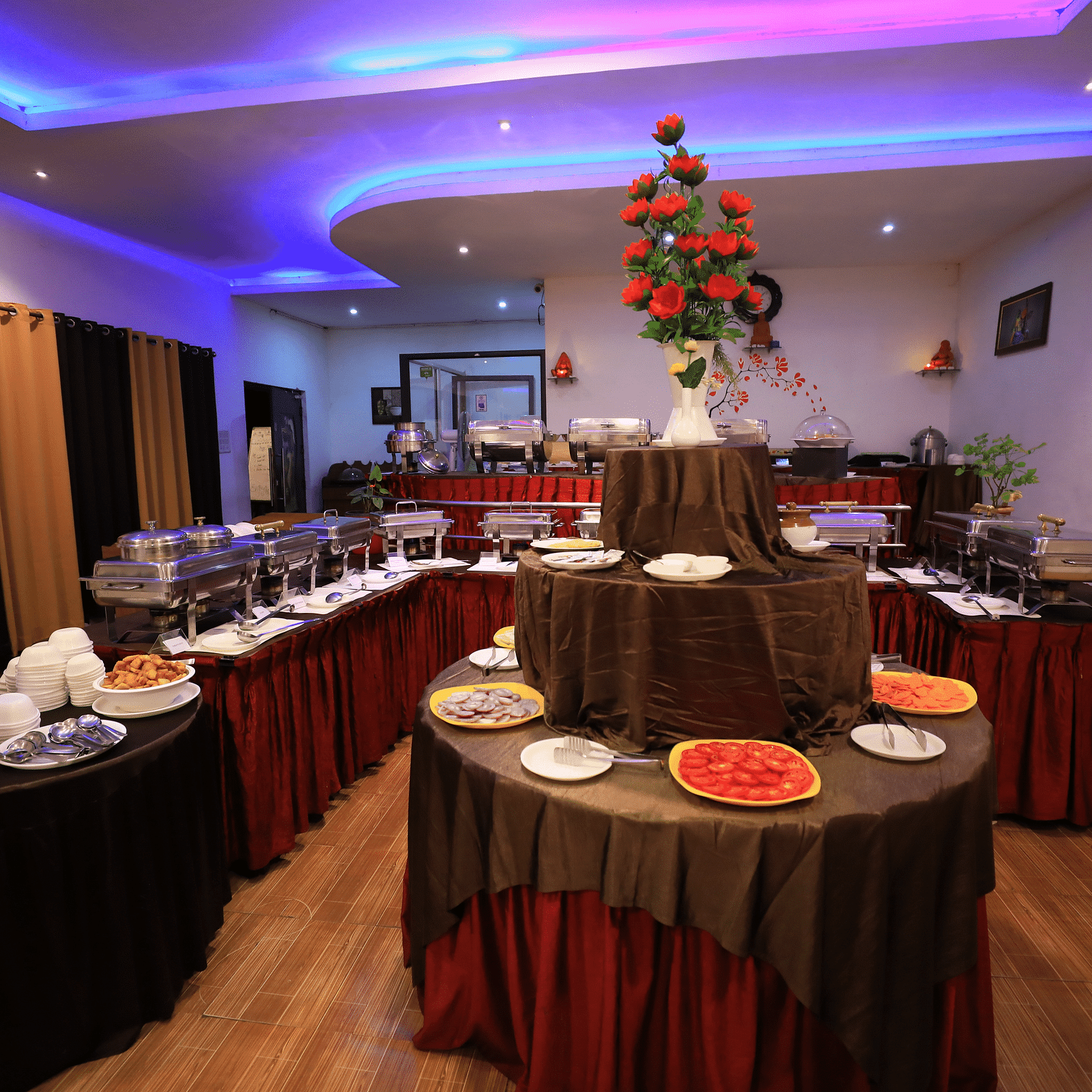 A buffet table with crockery arranged on it Coorg Jungle Camp Backwater Resort, Kushalnagar.