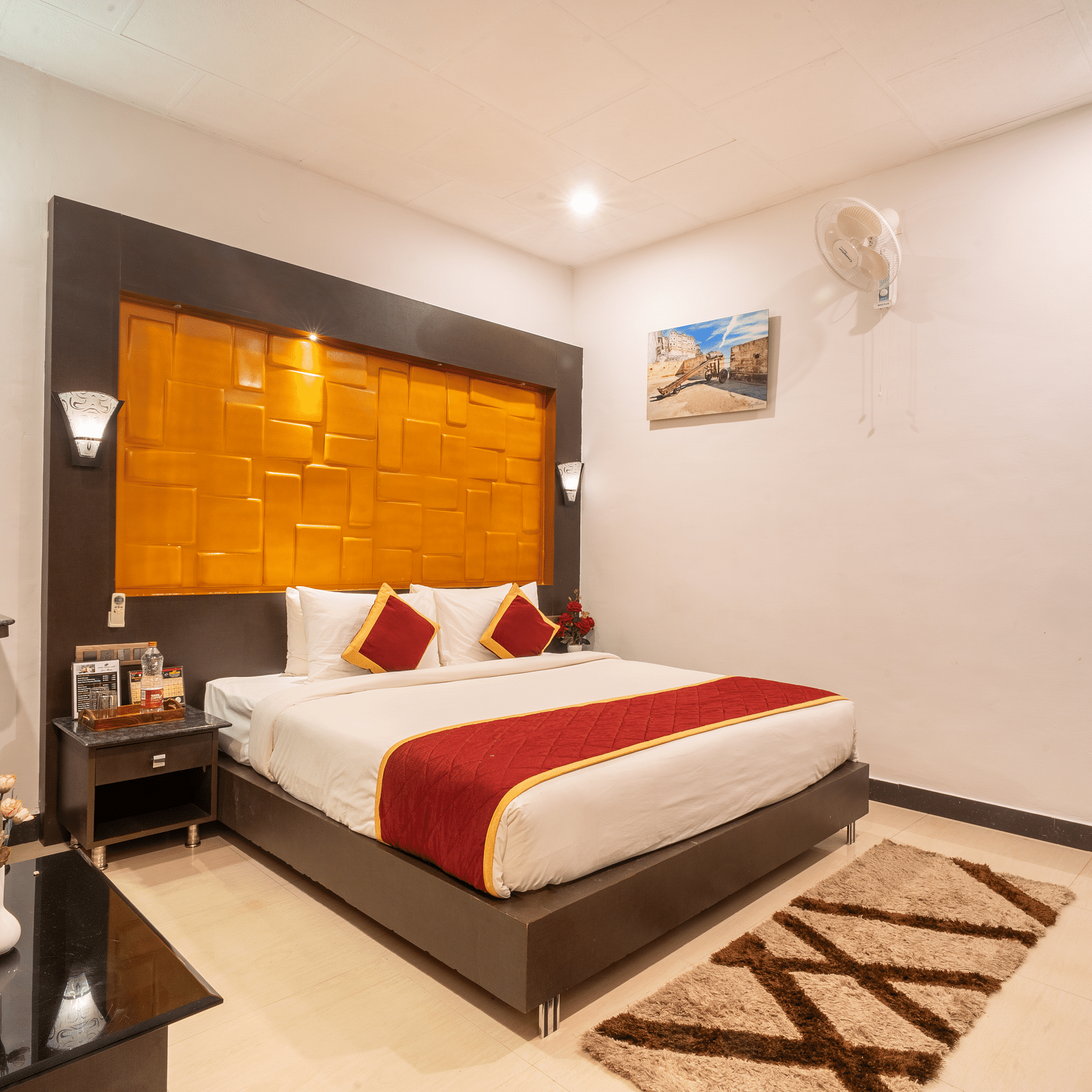A room with a bed and a rug placed in front of it at Coorg Jungle Camp Backwater Resort, Kushalnagar.