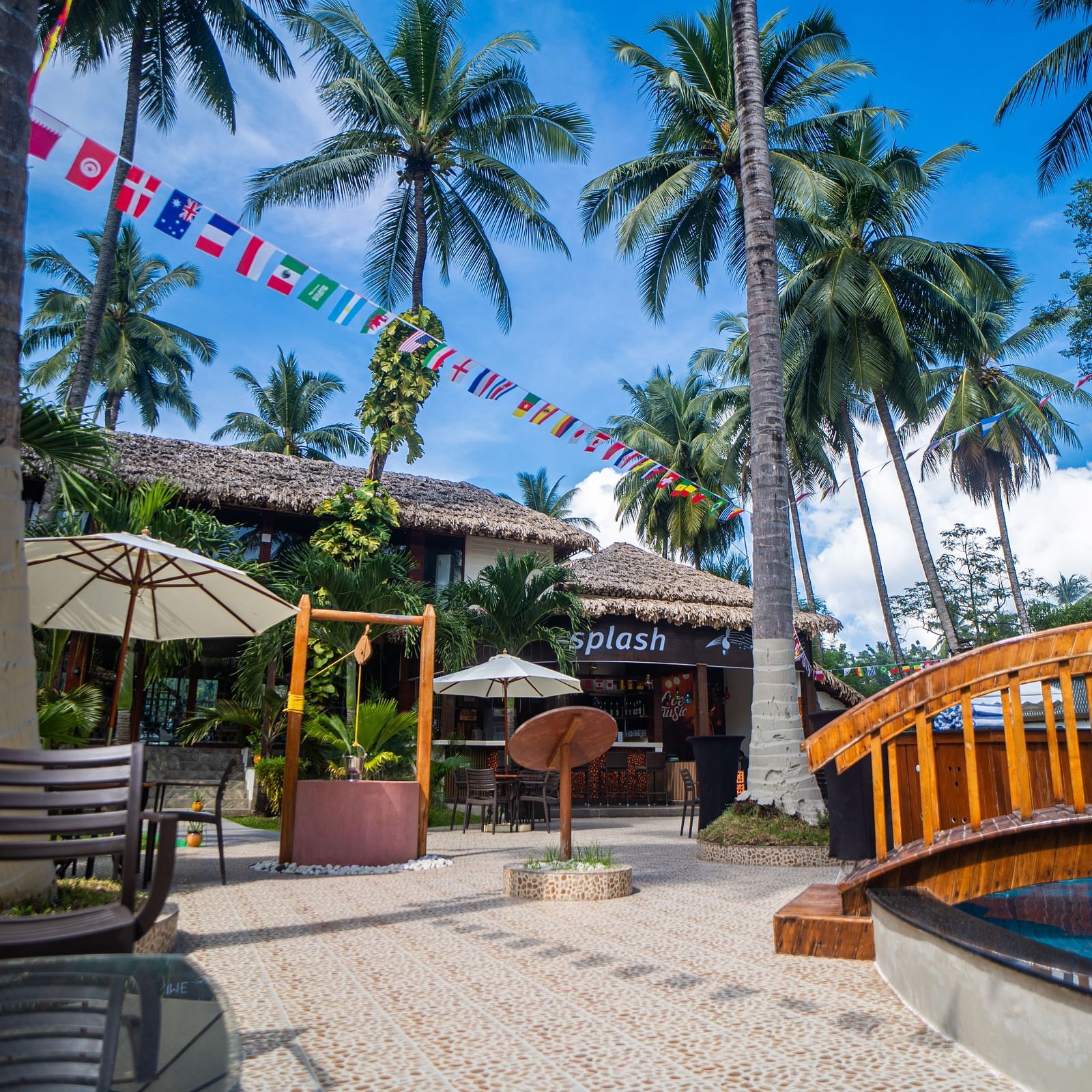 Poolside with coconut and trees at Coral Reef Hotel & Resort