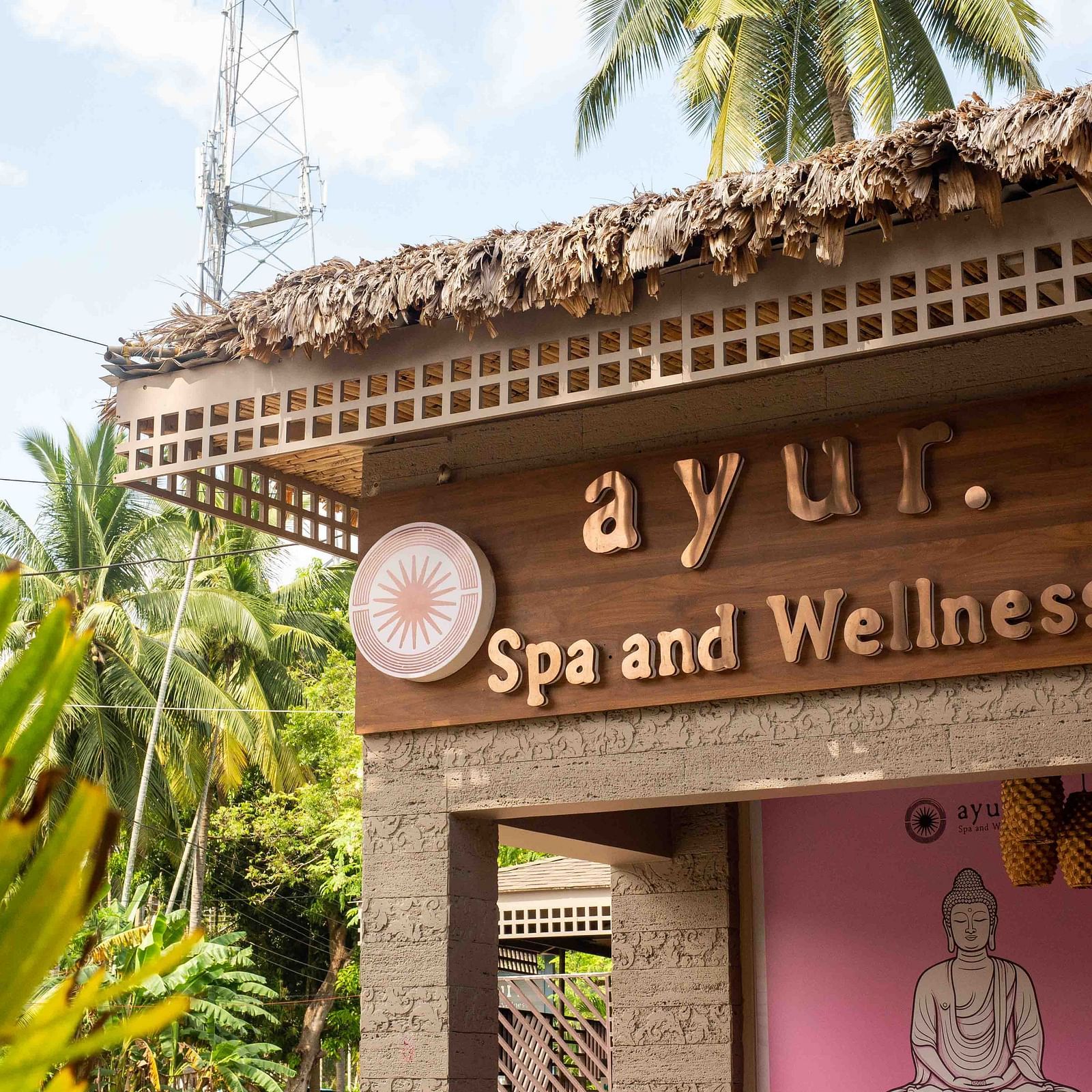 A sign for the Ayur Spa and Wellness centre at Coral Reef Hotel & Spa in Havelock with an elegant design featuring a calm, relaxing atmosphere. The surrounding greenery adds to the peaceful setting - Coral Reef Resort & Spa, Havelock