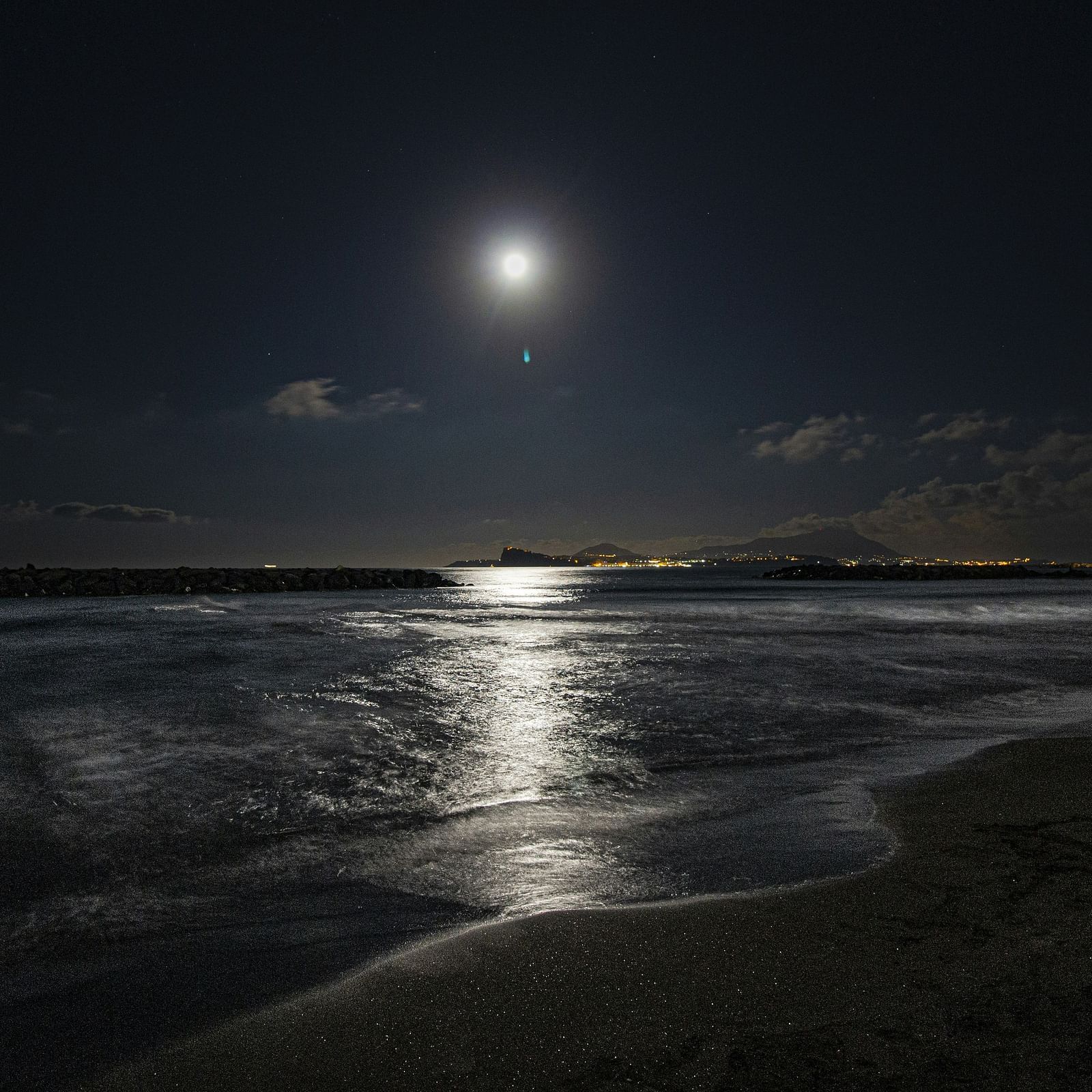 A serene view of a beach under moon light