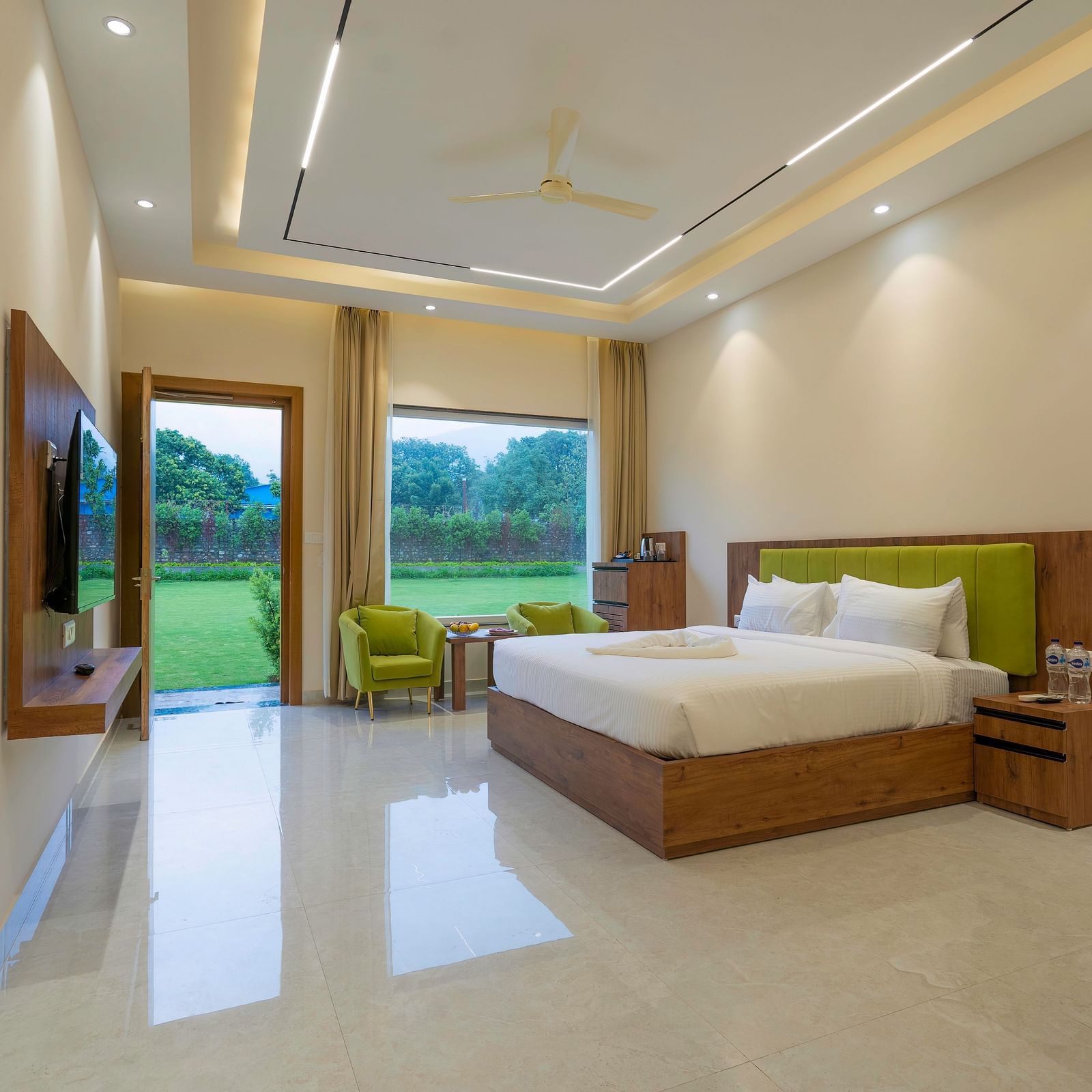view of the lush lawn from the luxury room with bathtub at Corbett Four Seasons, Ramnagar