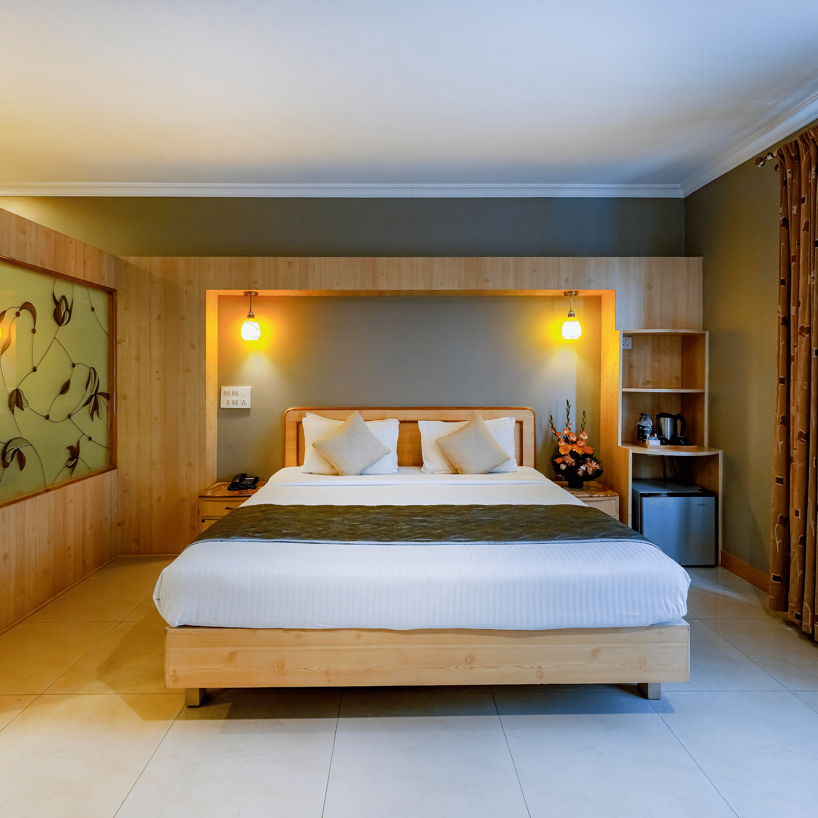 An elegant Suite with a stylish headboard and large bed - Cross Roads Inn, Bengaluru