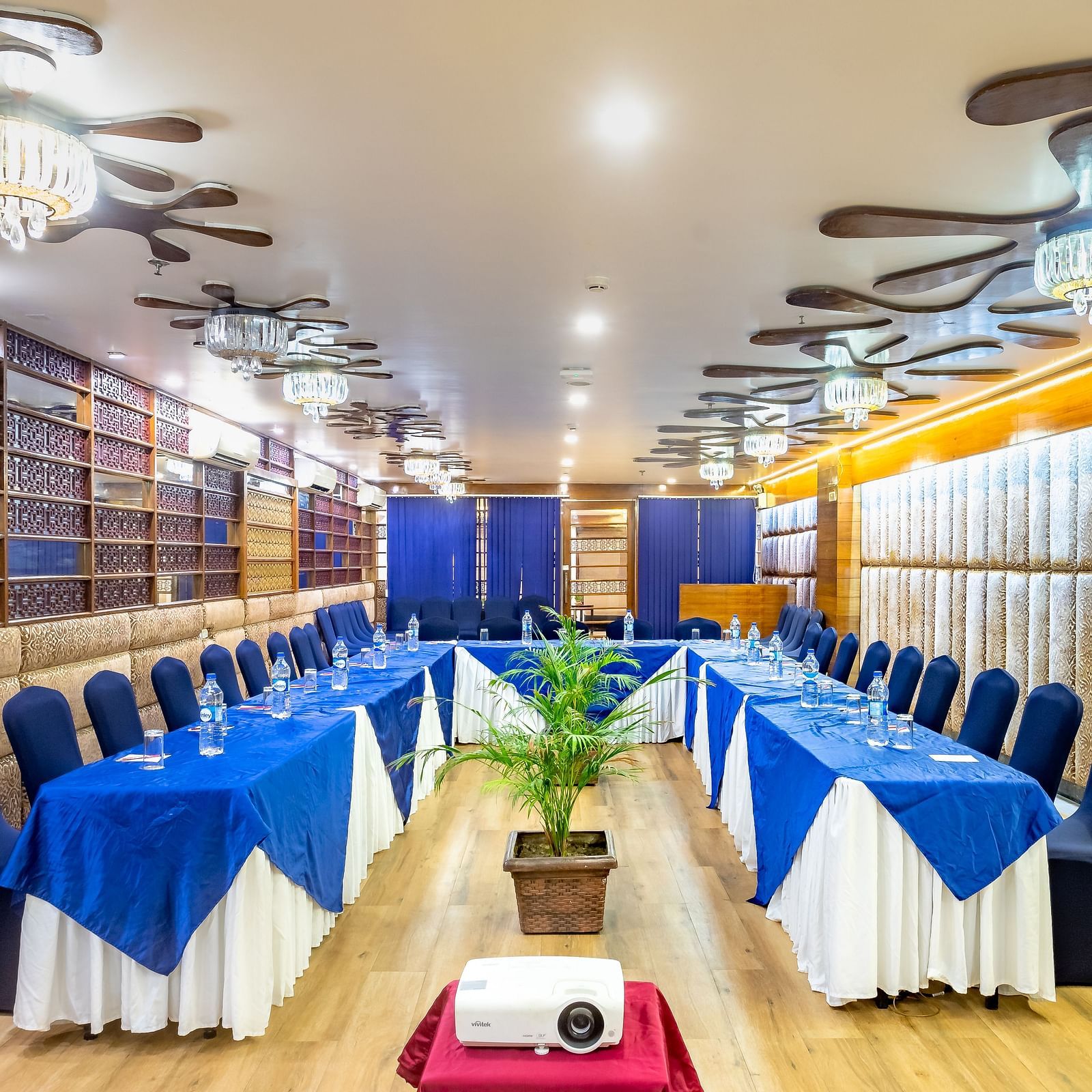 Meeting room at Diamond Palace Lords Plaza Nepalgunj with a U-shaped table facing a screen and decorated walls.