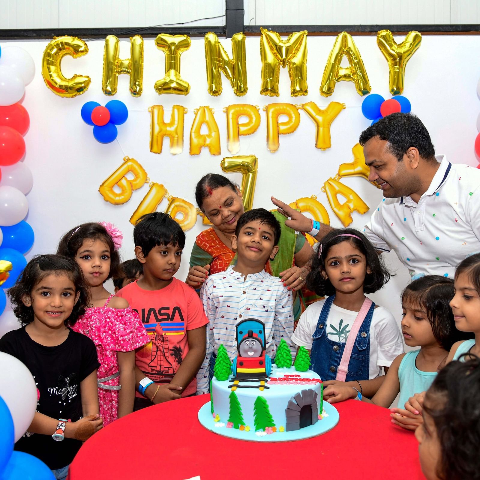 A group of children in front of a birthday cake - Diamond Parks, Pune 