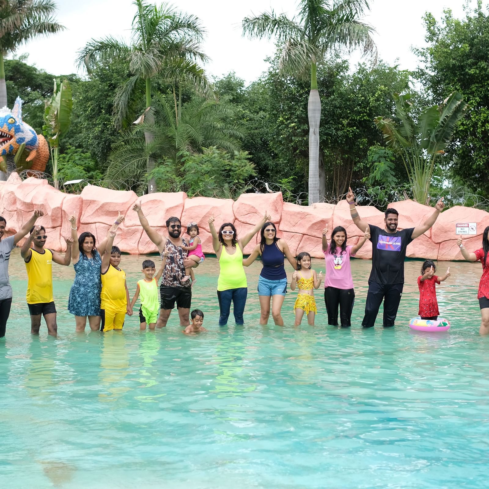 Group of friends posing joyfully in a shallow water pool at a theme park | Diamond Parks, Pune 