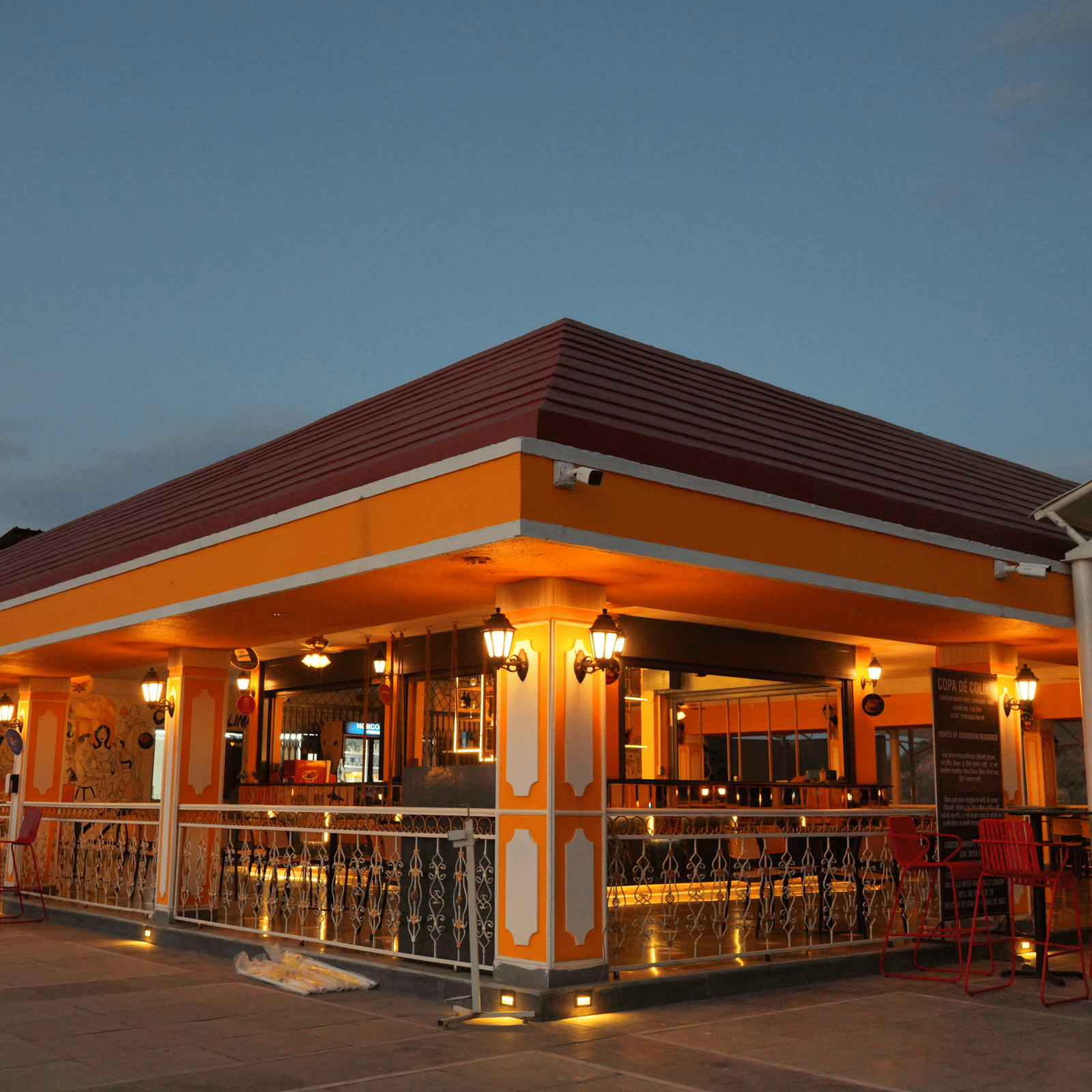 A facade view of the hotel Copa de Colina during twilight with the lights on, ideal for the perfect Photoshoot in Pune.