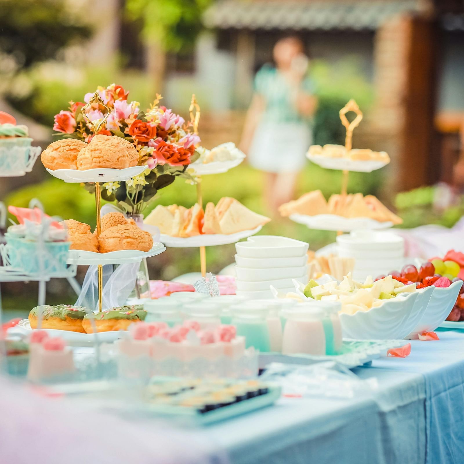 An outdoor dining arrangement with children playing in the backdrop