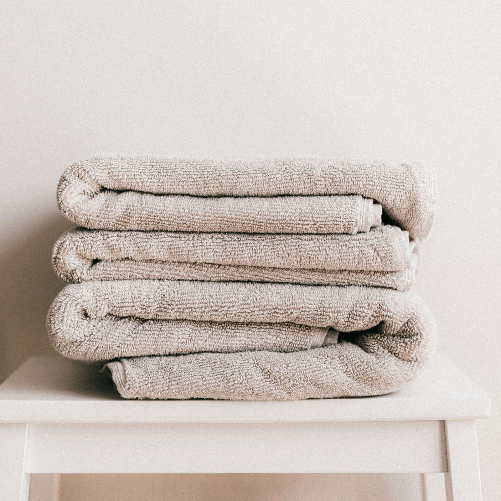 white coloured towels neatly folded and kept on a stool