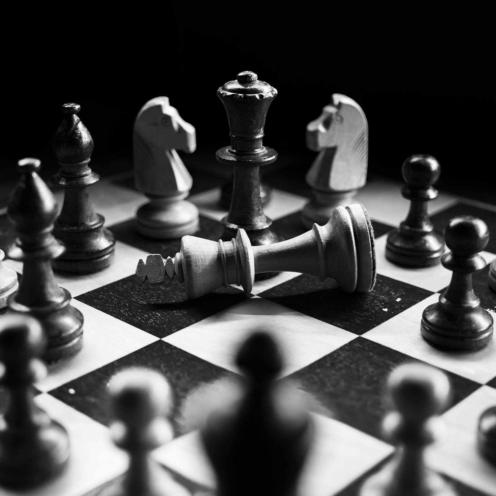 A chessboard with pieces in the middle of a game, with the white king and rook attacking the black king.