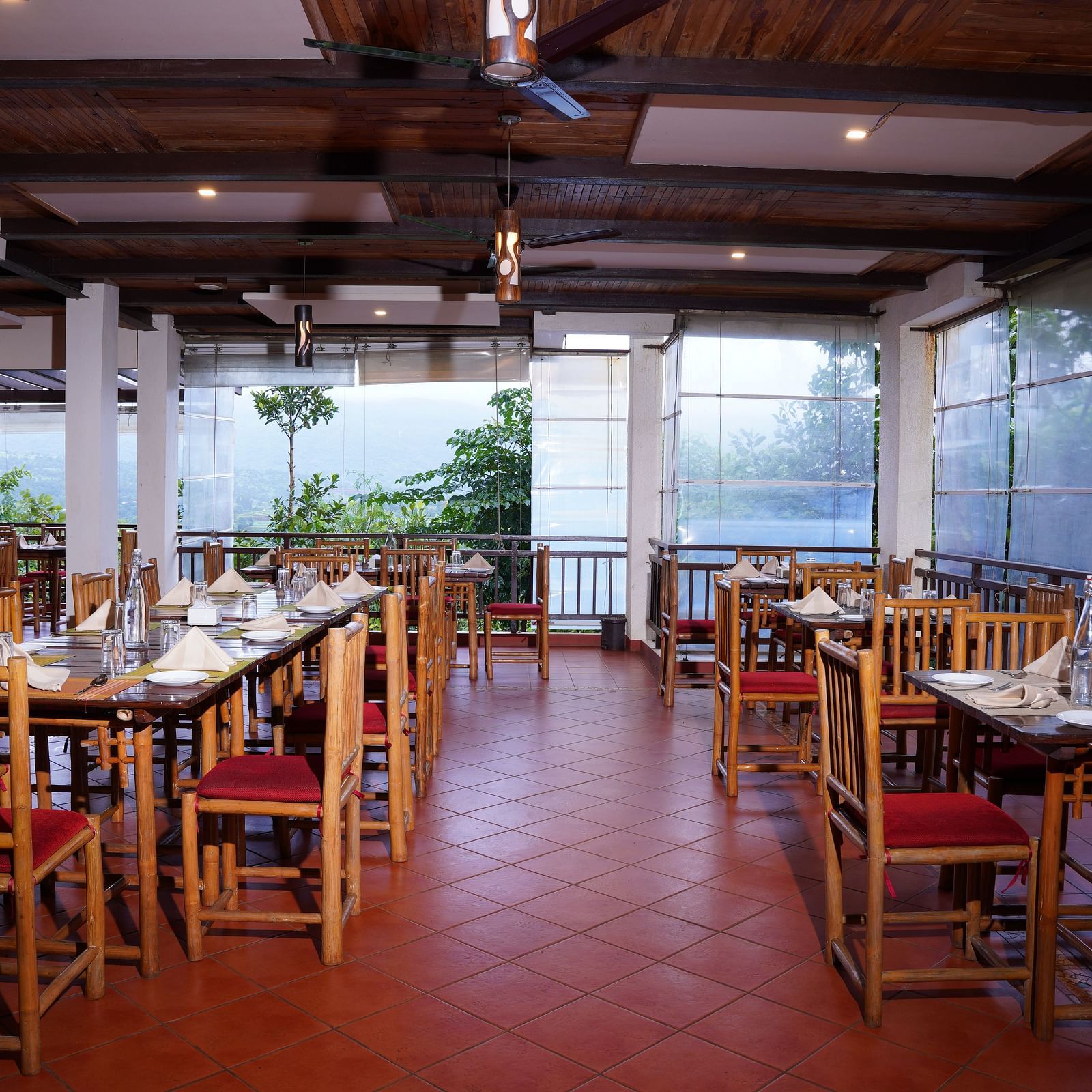 Another view of the dining space at Forest Escapes Koyna, showcasing the arrangement of tables and chairs.