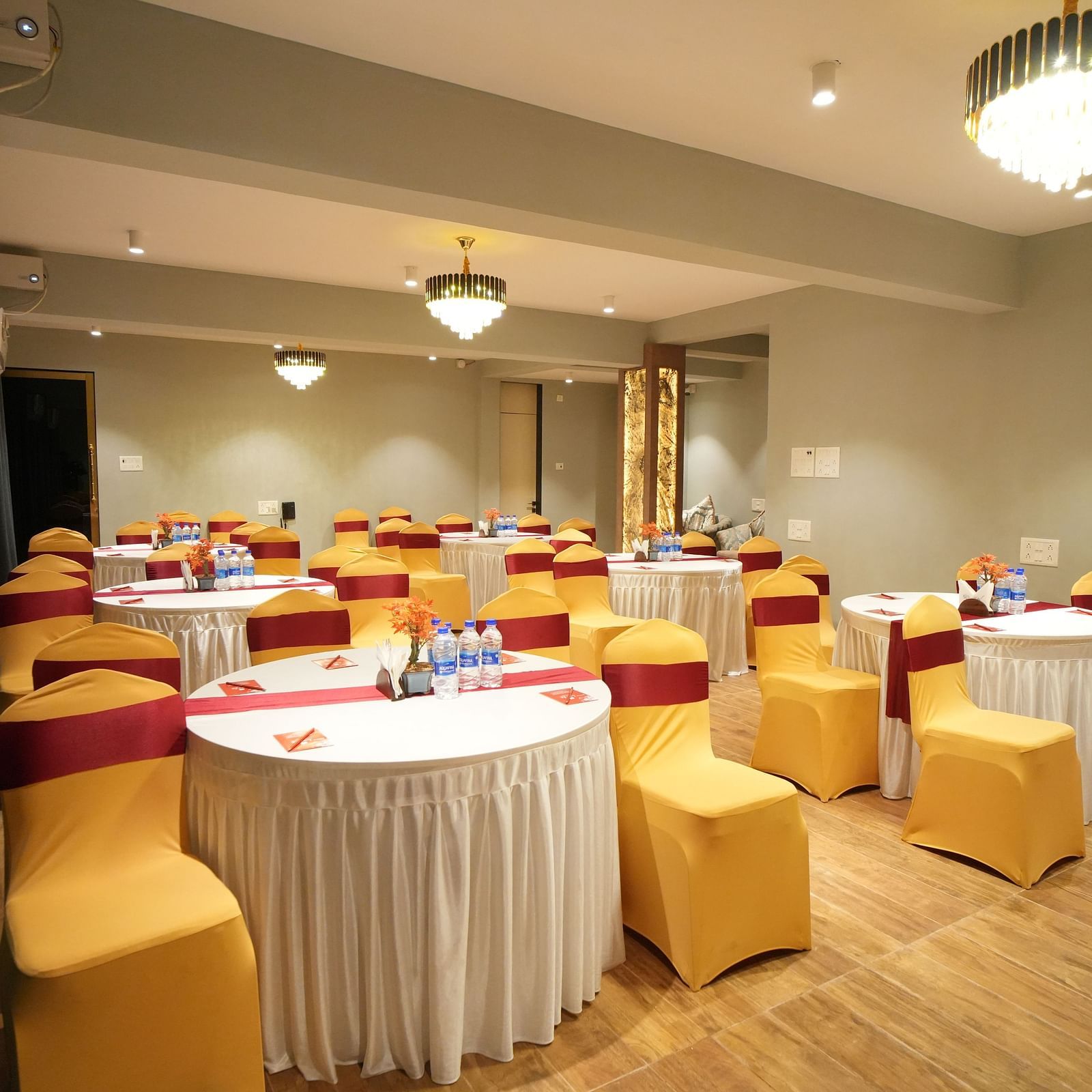 A class room style seating arrangement with chandelier lights