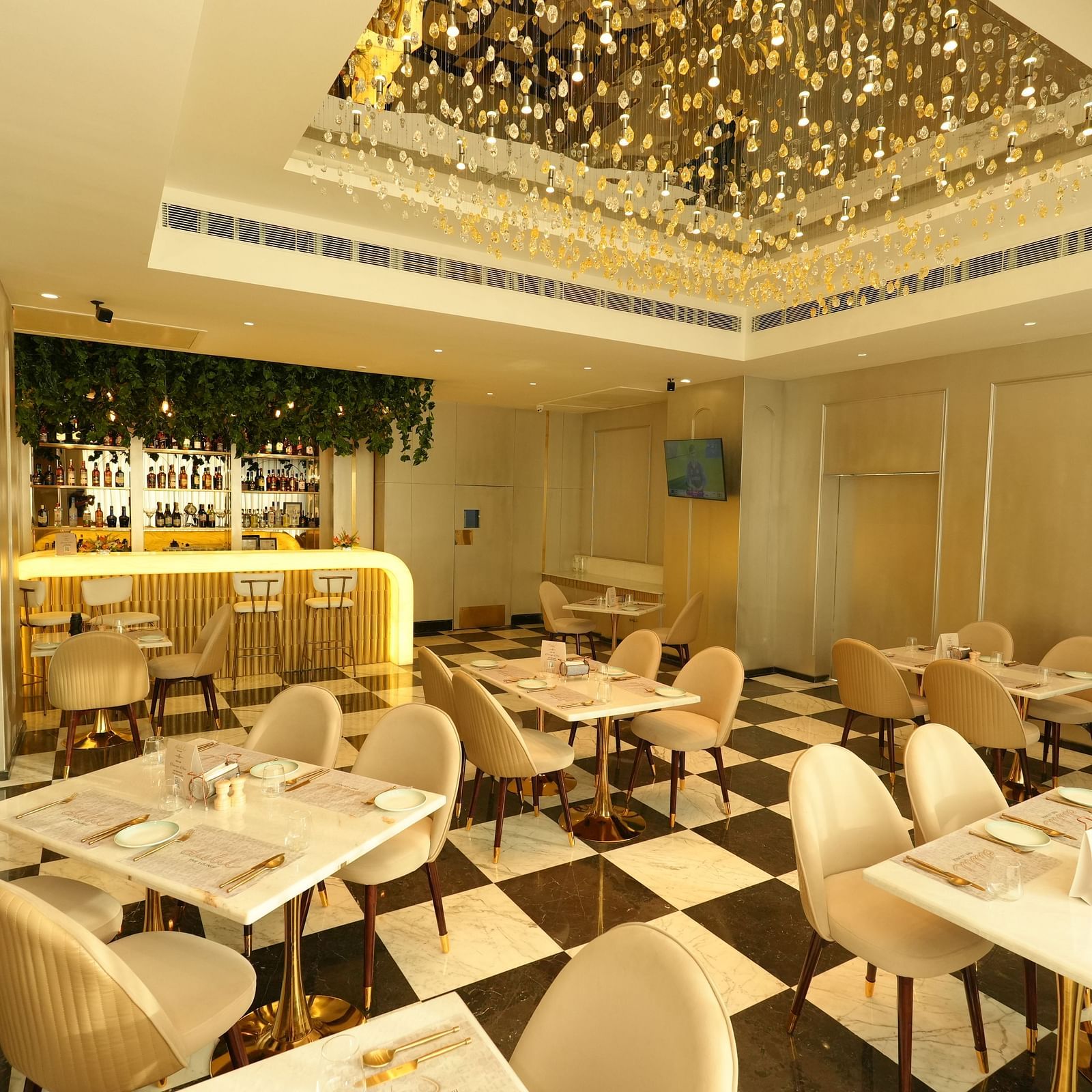 Stylish restaurant interior with modern decor and chandelier lighting at Grand Plaza Lords Inn Jammu.