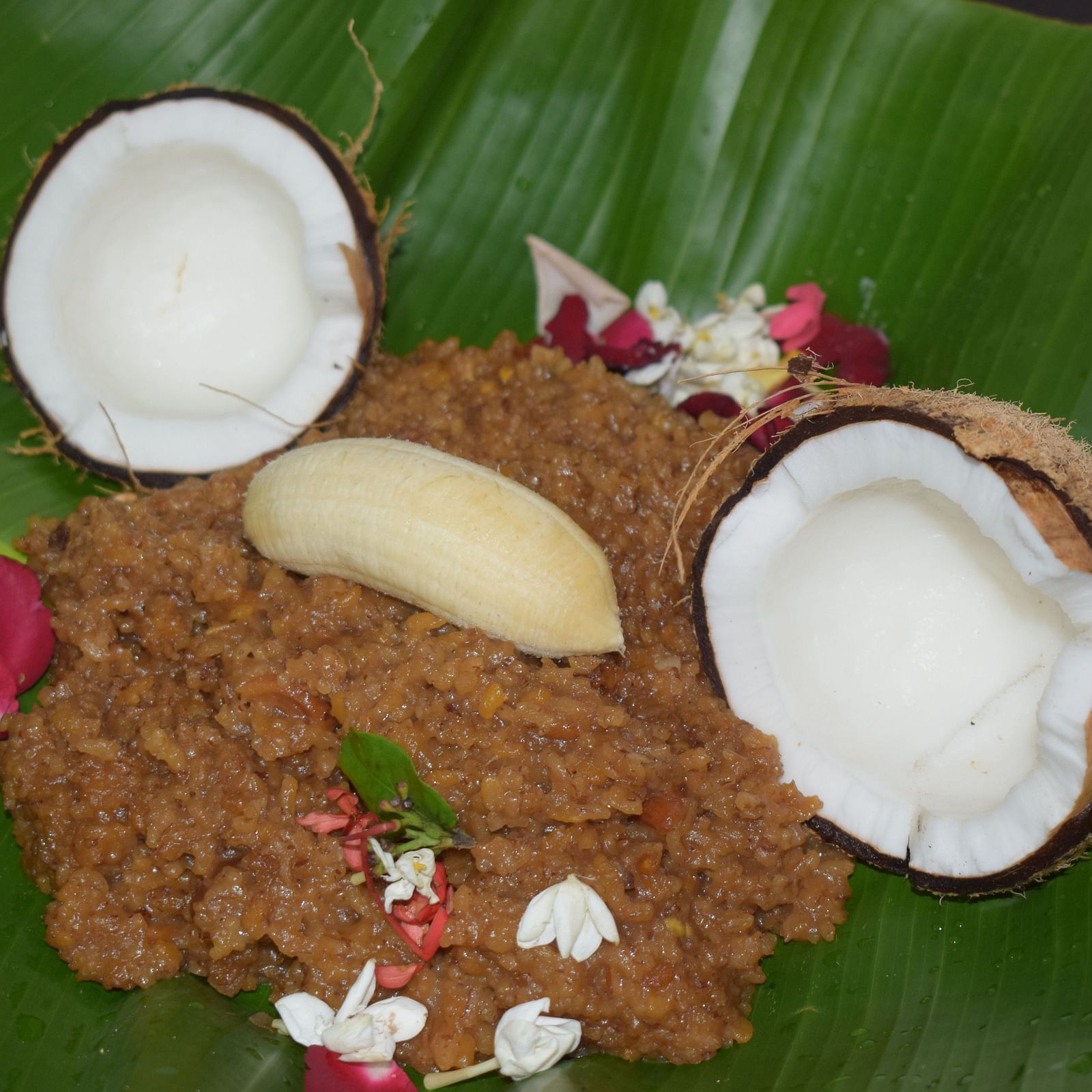 Traditional South Indian sweet paste with grated coconut pieces on a banana leaf.