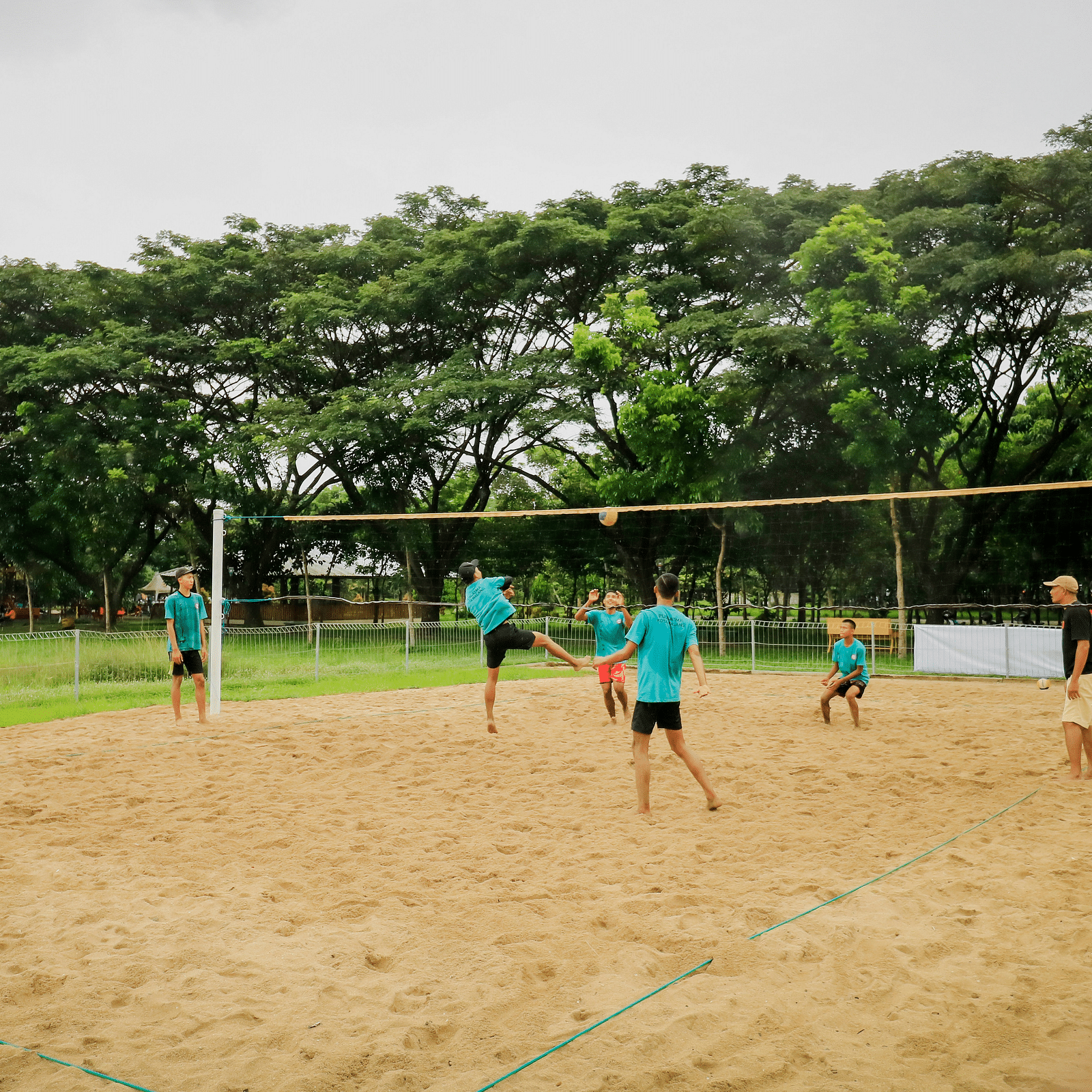 Image of a playground where people are playing volley ball