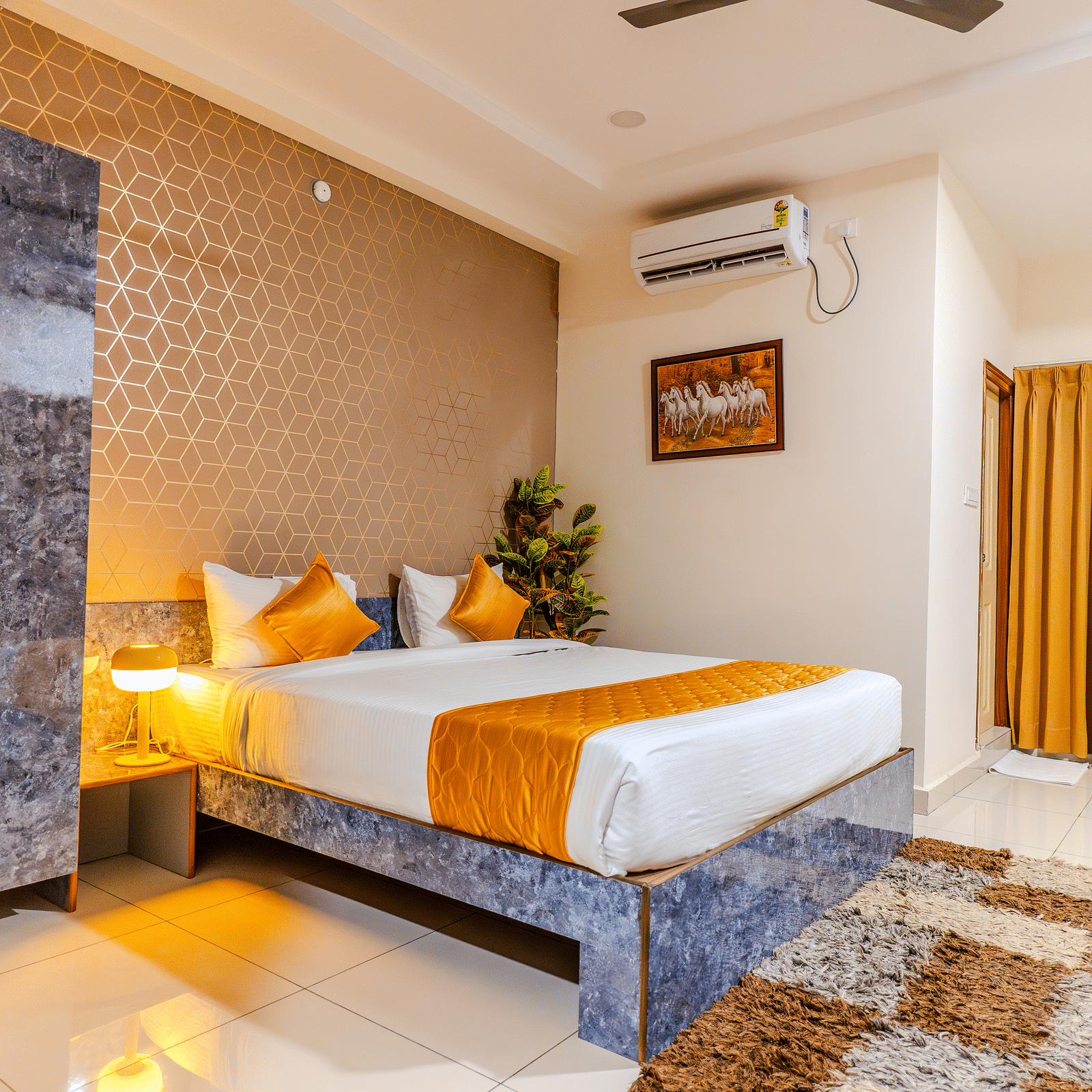 An image of a bedroom equipped with AC, wardrobe, and a table - Hotel Aerotel, Hyderabad - A Unit of Comfort Hometel
