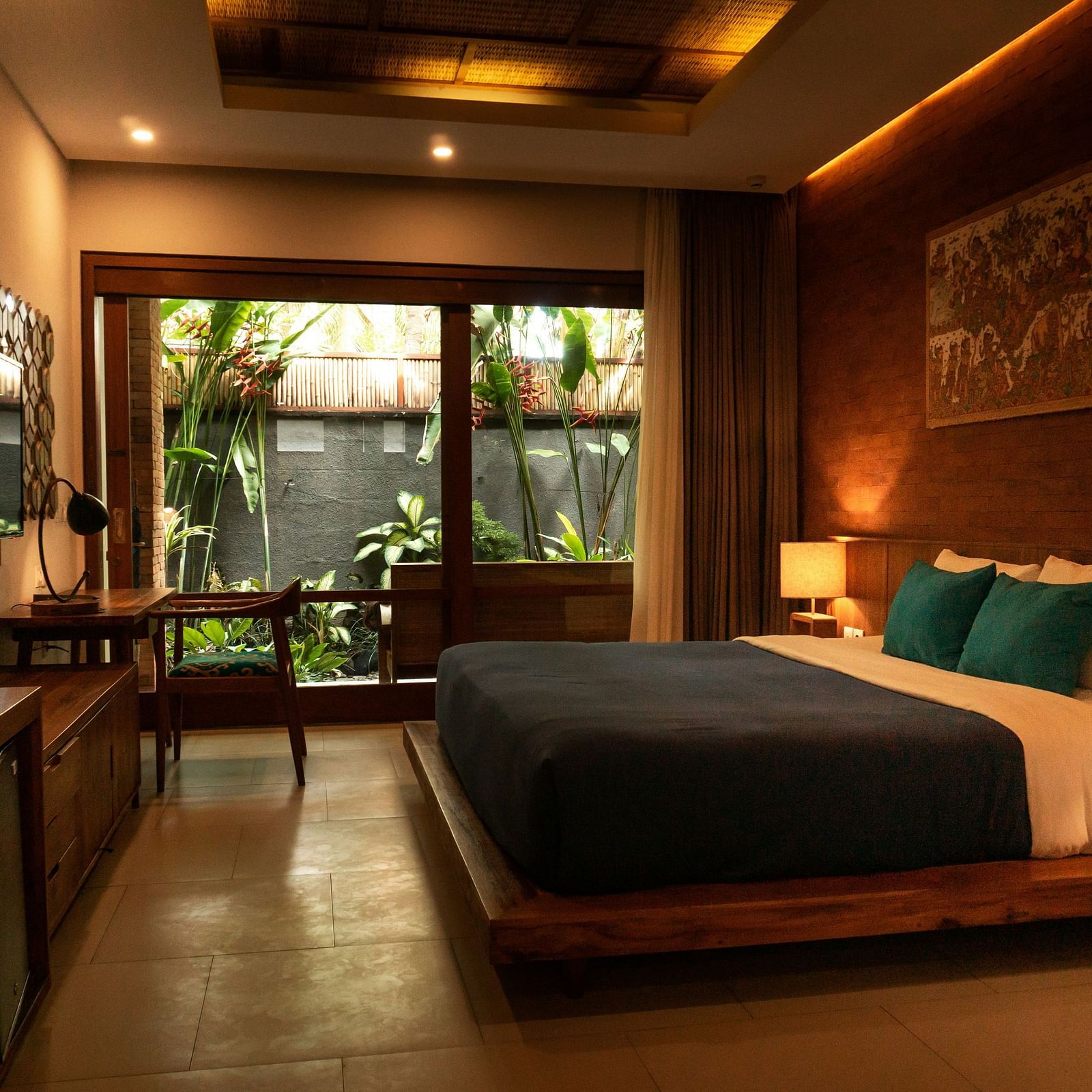 a double bed inside a room with side table and lamps next to it