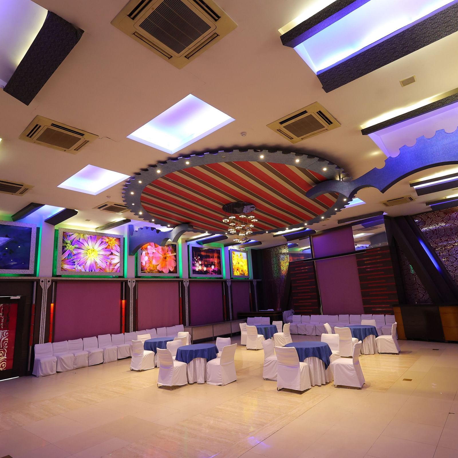overview image of Amar Mahal of hotel Amar with cluster seating arrangement  and lavish decoration 